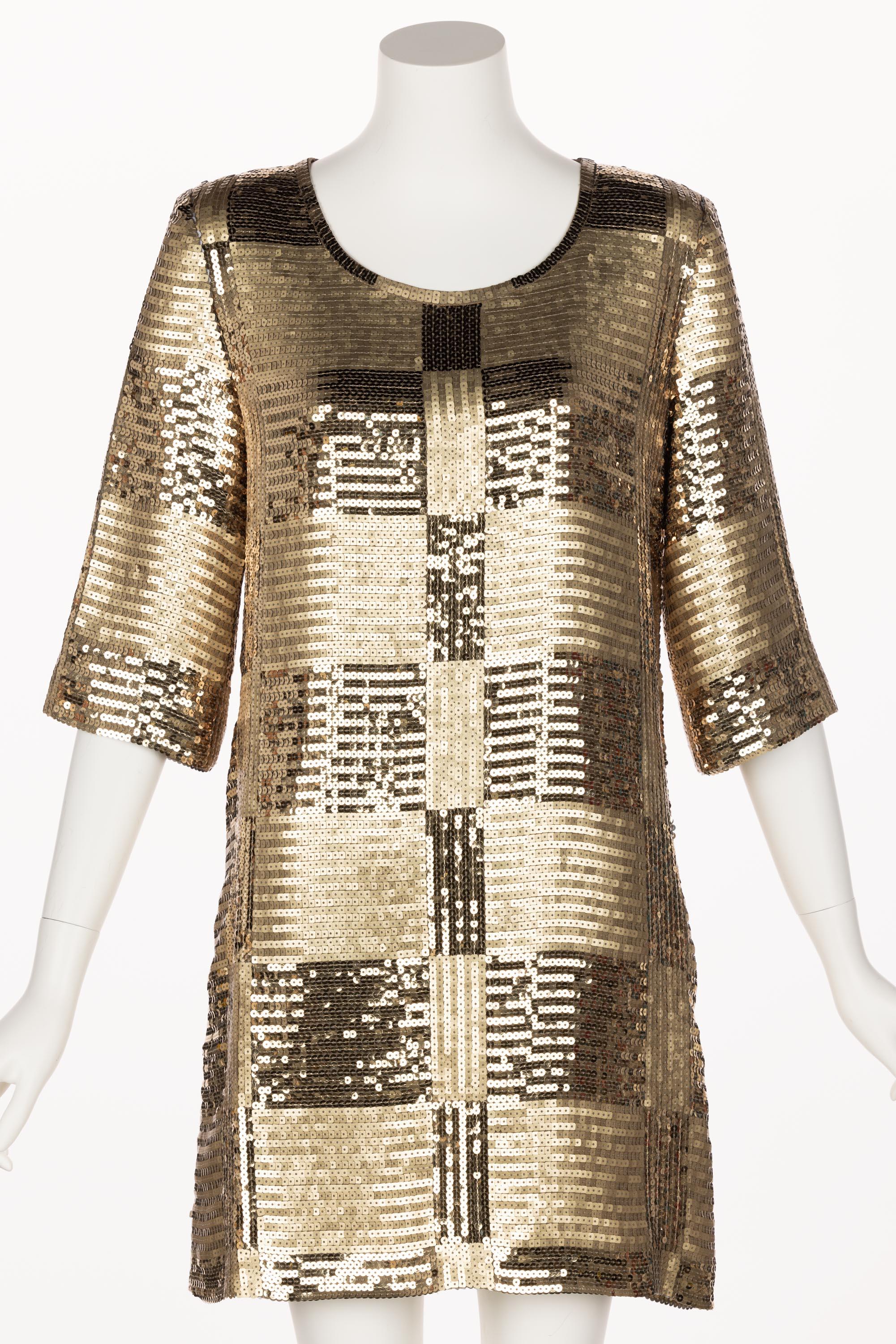 The designer of this tunic dress is unknown, but that makes it no less spectacular. Done in alternating boxes of matte and shiny gold sequins that create a lattice design, this dazzling dress is playful and sophisticated at once. The bodice begins