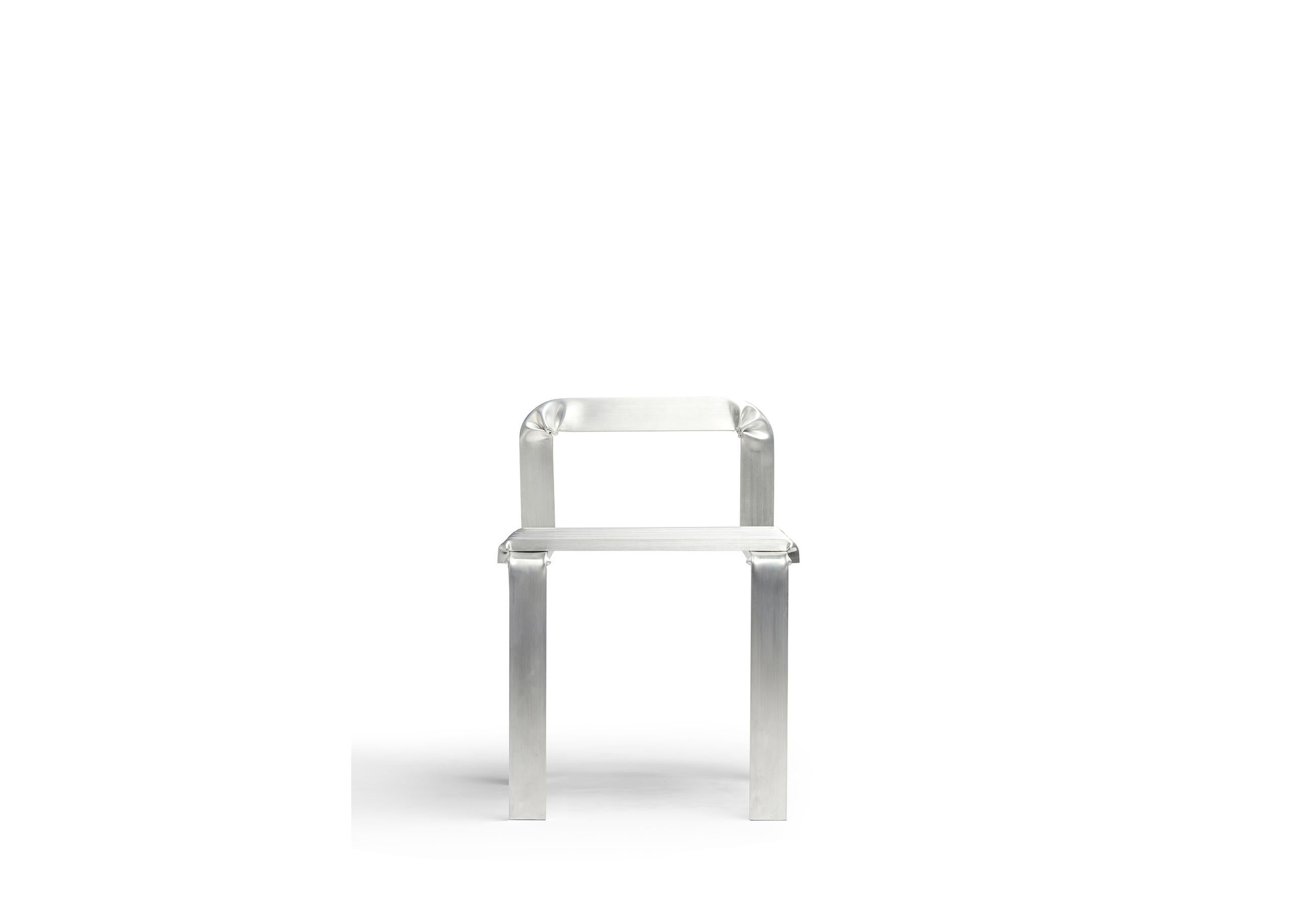 This wide chair with a low backrest is conceived as a path of folded aluminum box-pipe. Corners are deformed manually in a demonstration of material plasticity. 

The concept for the Unstressed chair moves from the exploration of metal plasticity