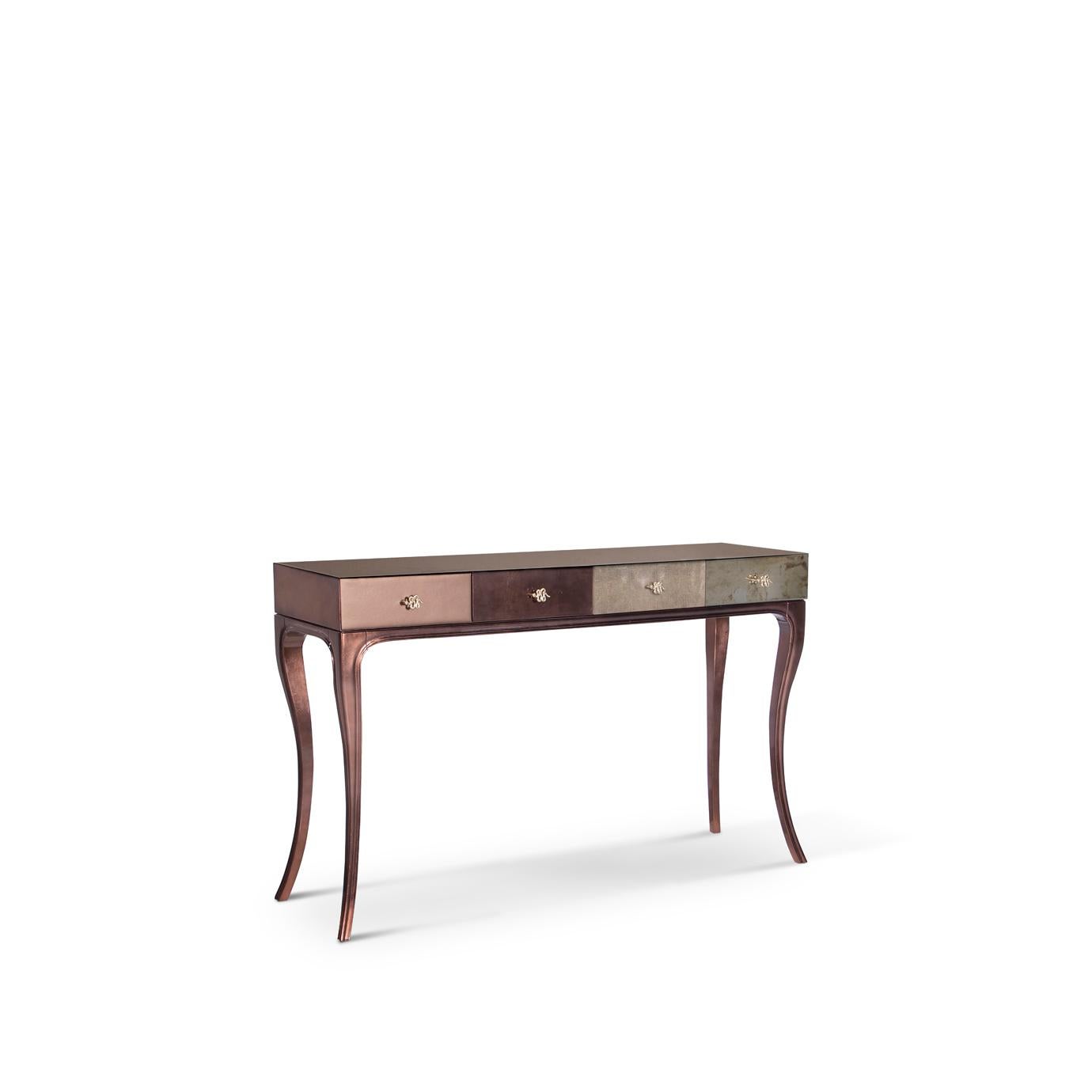 Fierce details packed with primal power, verve, and bite wrap this reptilian console. Drawer fronts are composed of various materials, finely refined by brass-coiled snake hardware.