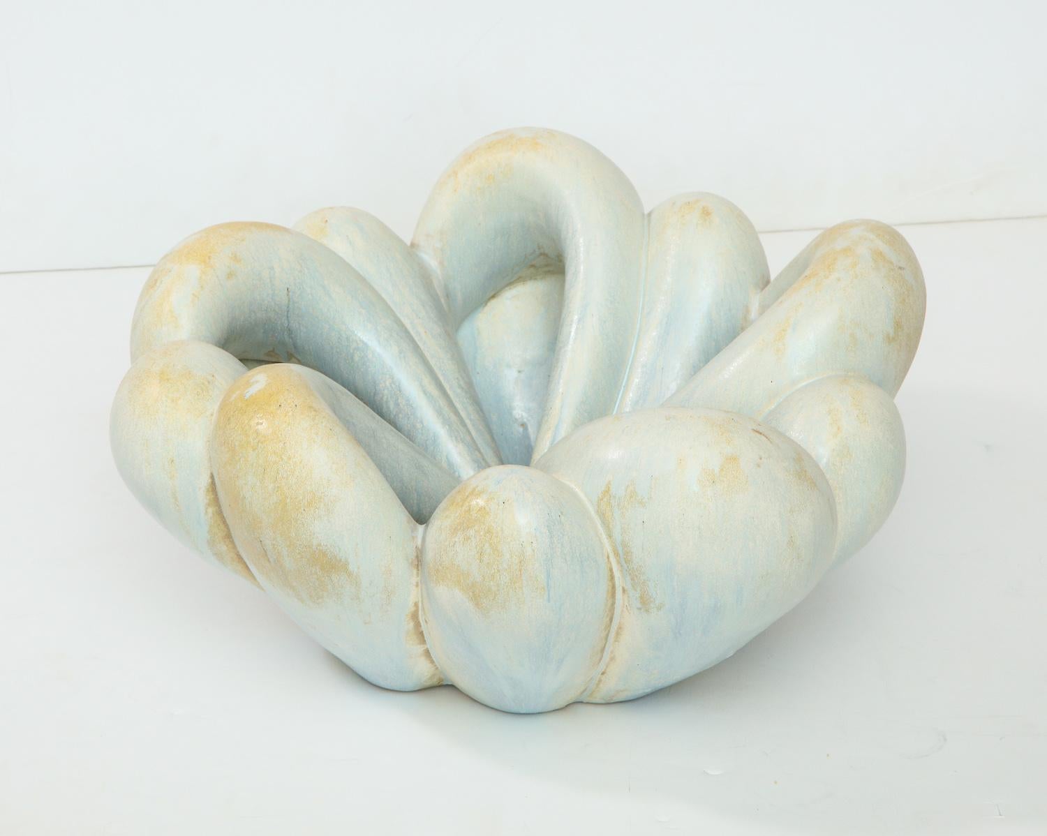 Hand-built stoneware vessel with bulbous ends and channeled design. Pale blue & brown glazes with interior glaze pooling.
  