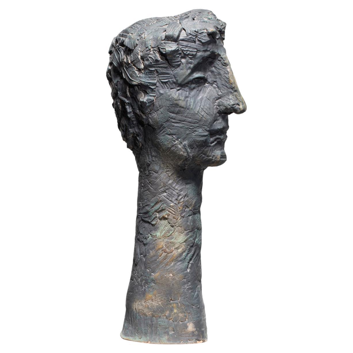 The UNTITLED portrait sculpture has a quiet yet powerful and commanding aura. The viewer cannot be around or near it without feeling its presence. It has a very classical approach in the large straight bridge of the nose and the head of curly hair