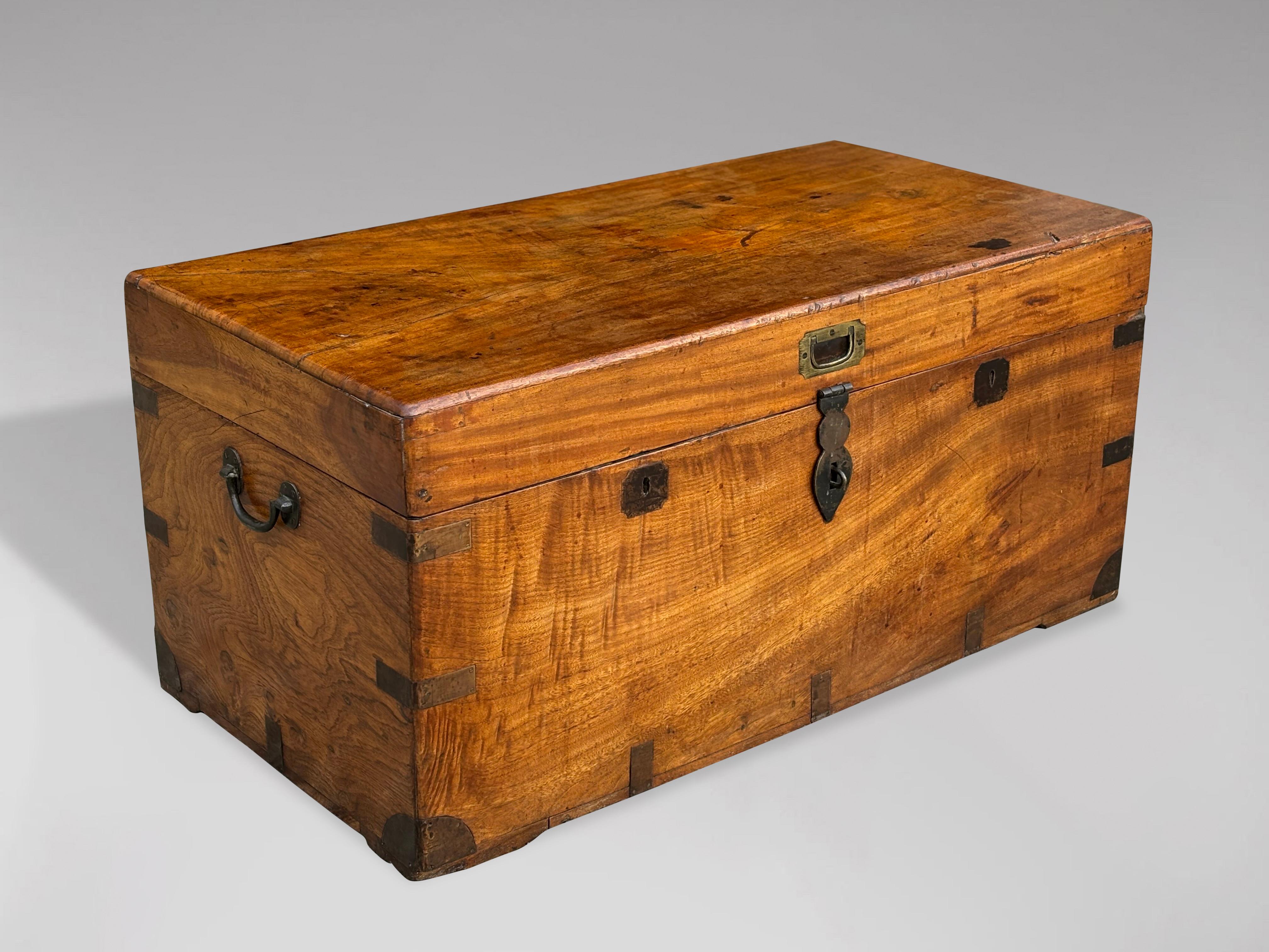 An untouched, charming, large late 19th-century camphor wood brass-bound traveling chest or trunk with brass mounts and handles. It features a warm, rich colour and patina, making it suitable for use as a decorative coffee table. The interior