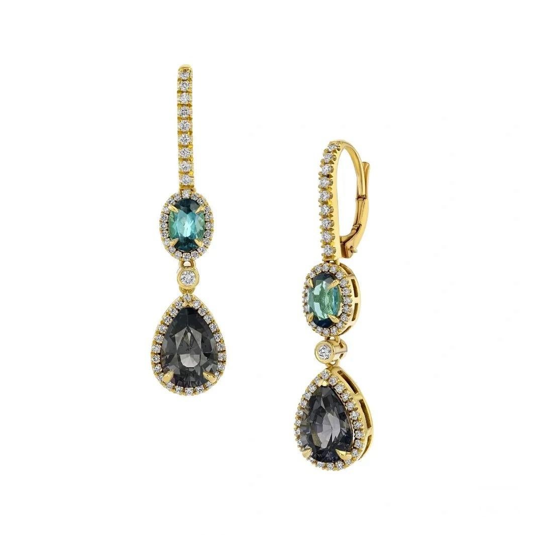 A truly unique combination of untreated gems. These 18K yellow gold earrings, feature 5.22 carats of Burmese Grey Spinels, paired with 0.88 carats of Brazilian Indigo Tourmalines, highlighted by numerous round diamonds. 

These timeless avant-garde