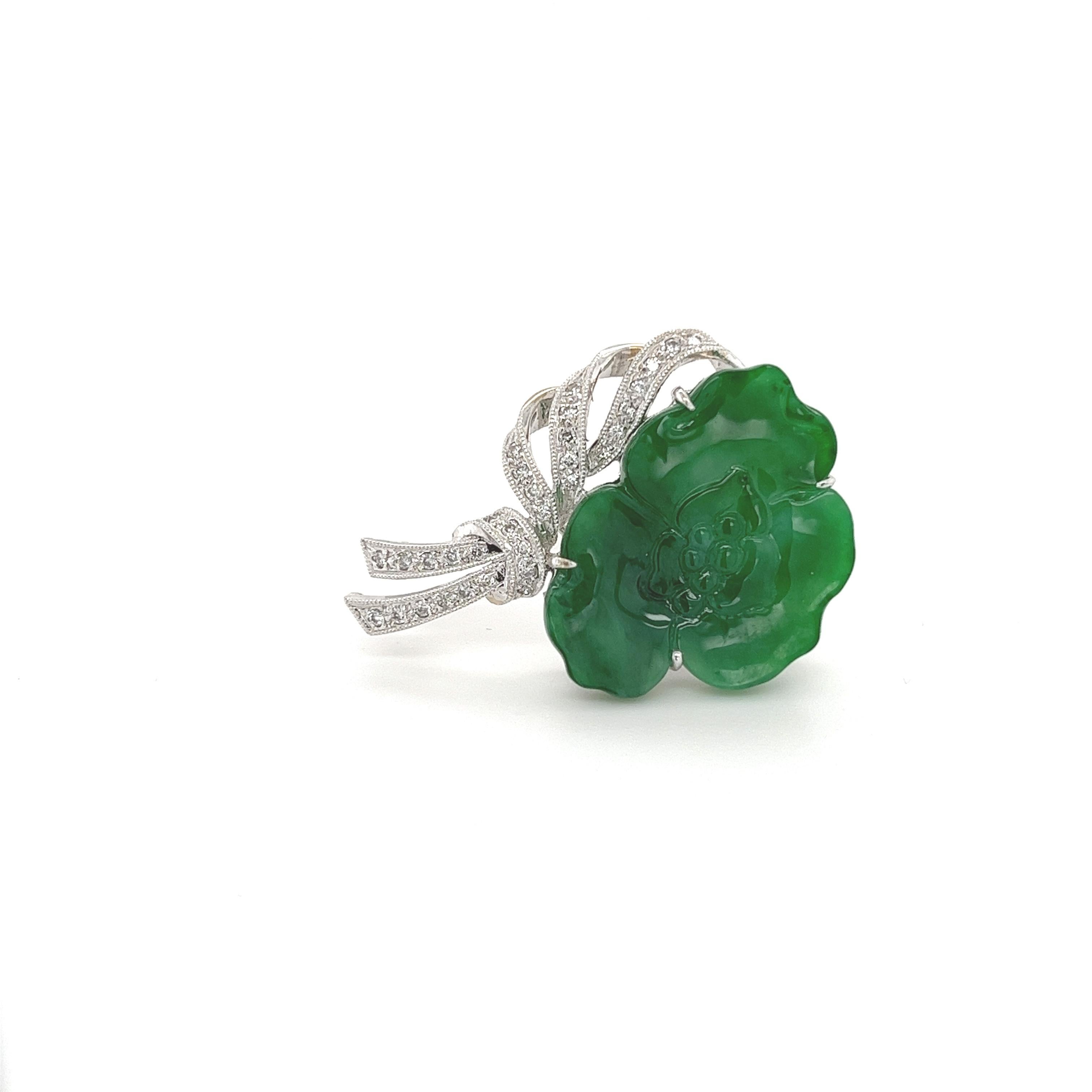 Untreated Burmese Jadeite Jade in a gorgeous floral grapevine motif design. Paired with 33 round brilliant cut diamonds in a gorgeous ribbon design. All set in 18 karat smooth white gold. This brooch has a sturdy closure with a safety clasp for