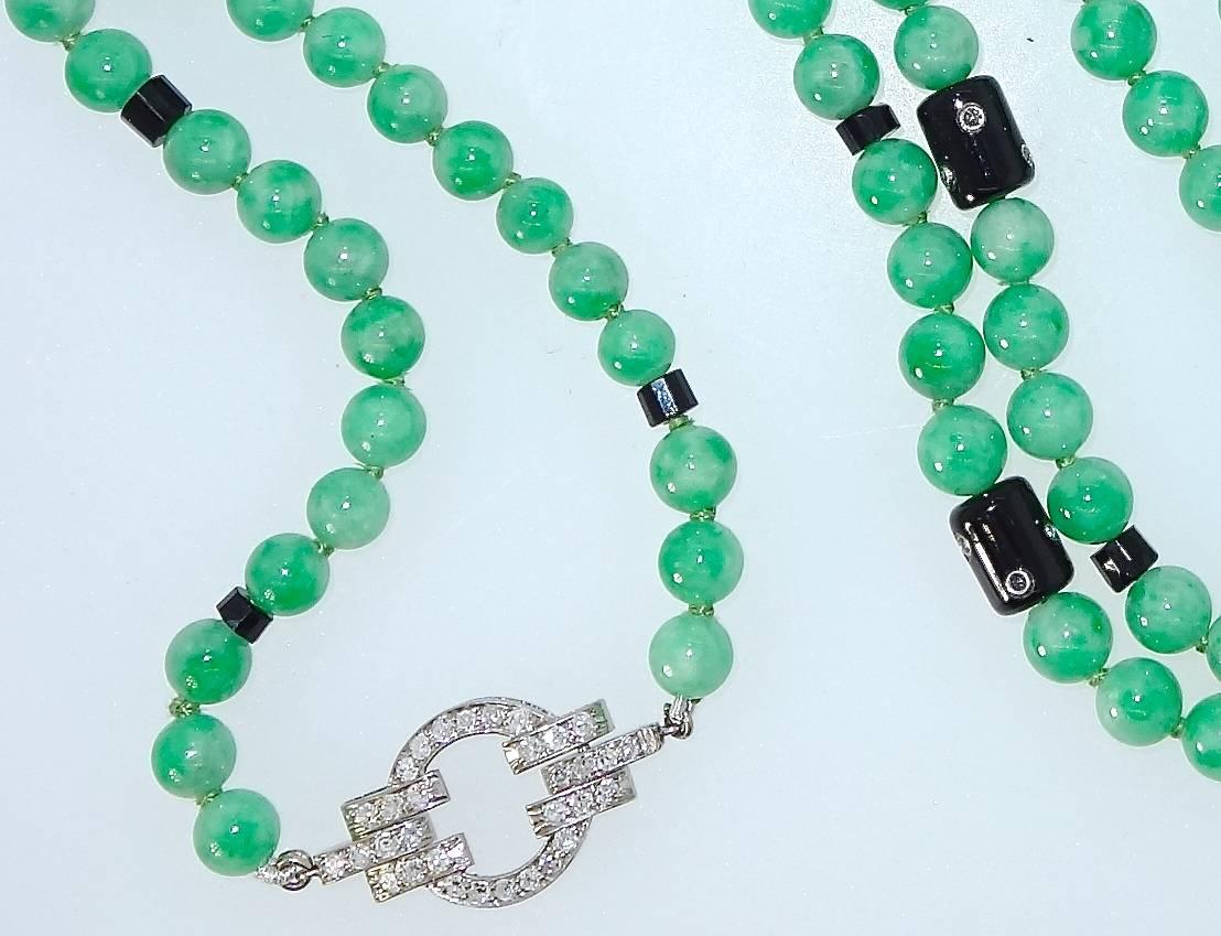 Natural, certified, untreated top grade jadeite-jade necklace with 173 fine matching beads, 7.5 mm., interspersed with platinum, onyx and small diamond elements.  This long necklace terminates with a fine platinum and diamond Art Deco clasp.