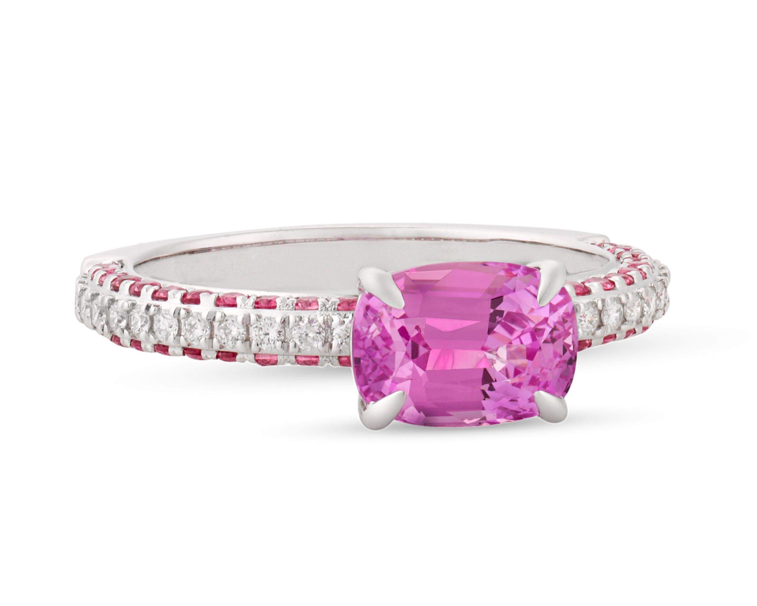 The 2.19-carat untreated pink sapphire in this ring exhibits a distinctive, saturated pink hue, among the rarest and most valuable colors in which to find one of these stones. This cushion-shaped gem is certified by Lotus Gold as a no-heat pink