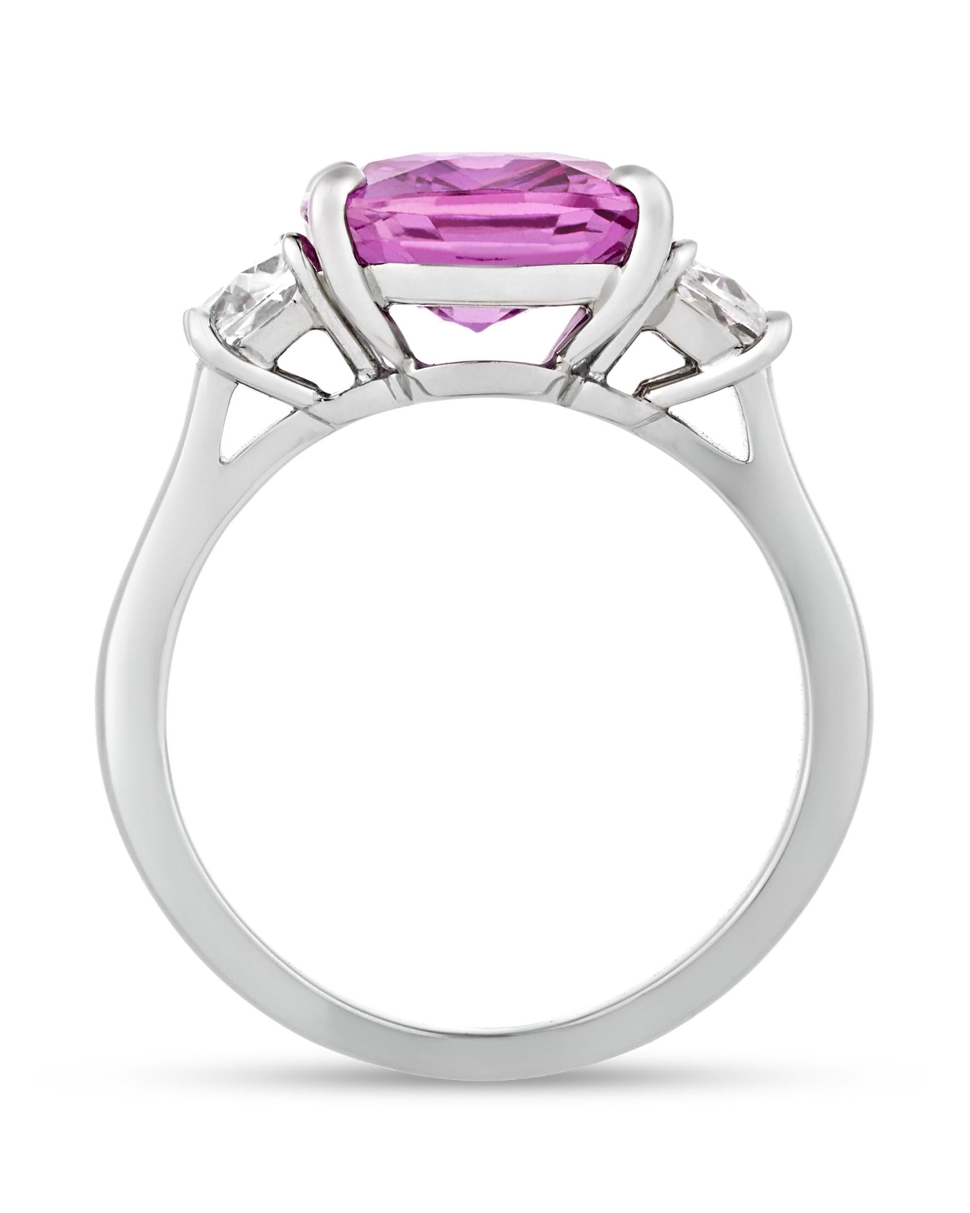 A deeply saturated cushion-cut pink sapphire weighing 5.07 carats is set in this classic ring. The stone is certified by C. Dunaigre of Switzerland as showing no indication of heating, meaning that it is entirely untreated with a natural hue.