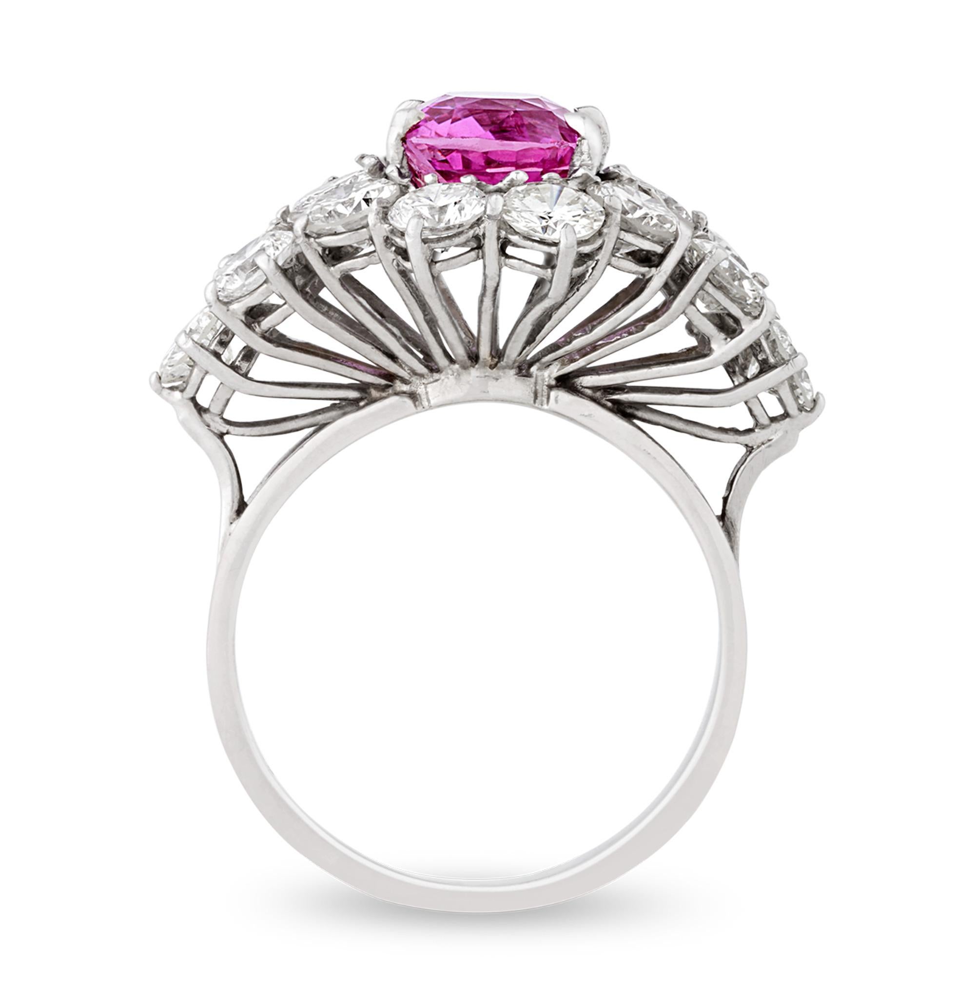 Vivid and completely untreated, this extraordinary ring showcases a 3.24-carat purplish pink sapphire, which displays remarkable saturation and brilliance. Accompanied by a GIA report, the cushion mixed cut gem is confirmed to be entirely natural,