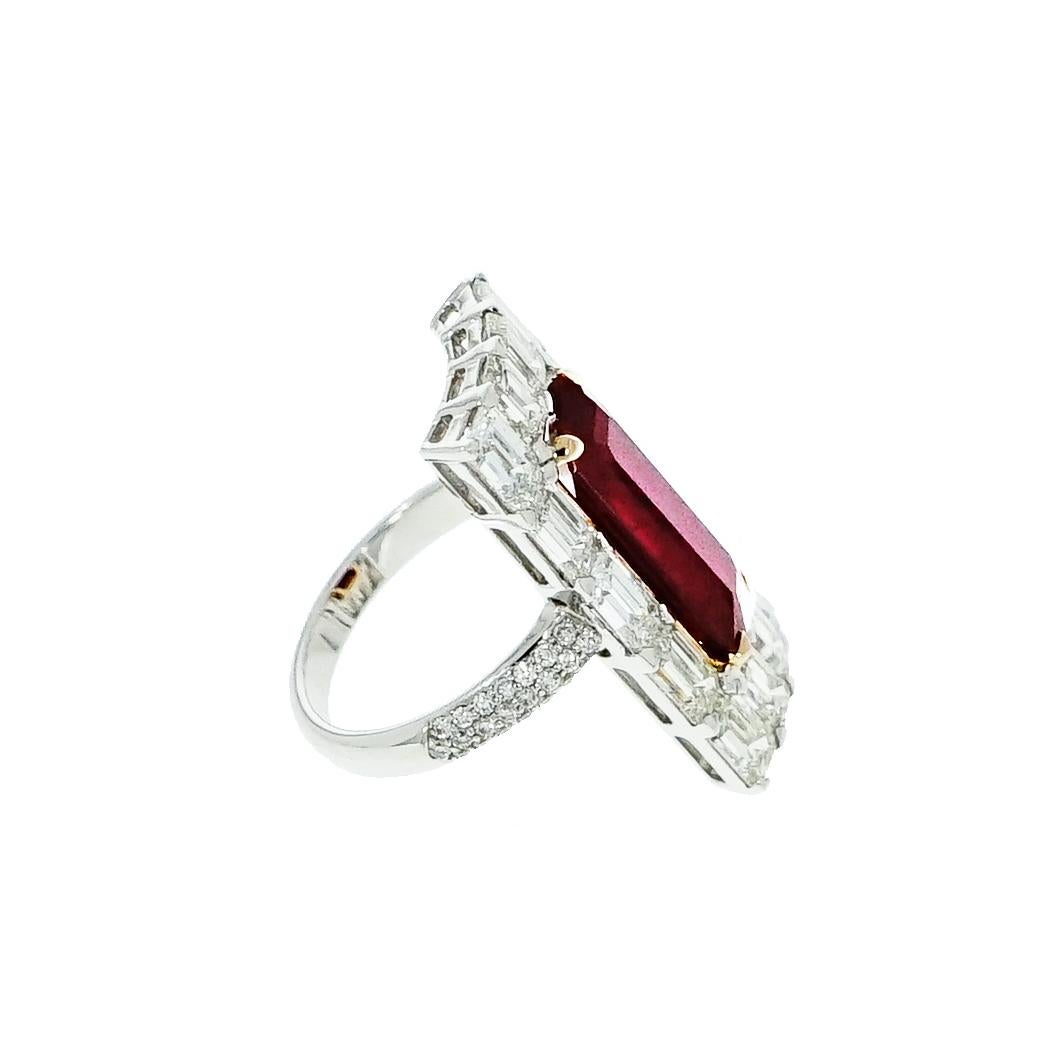 Ruby and Diamonds come together to enhance their beauty in this amazing creation.
This precious Cocktail Ring features an elongated emerald cut Ruby center that weighs 6.46 carats and is surrounded by 14 emerald cut Diamonds weighing approximately