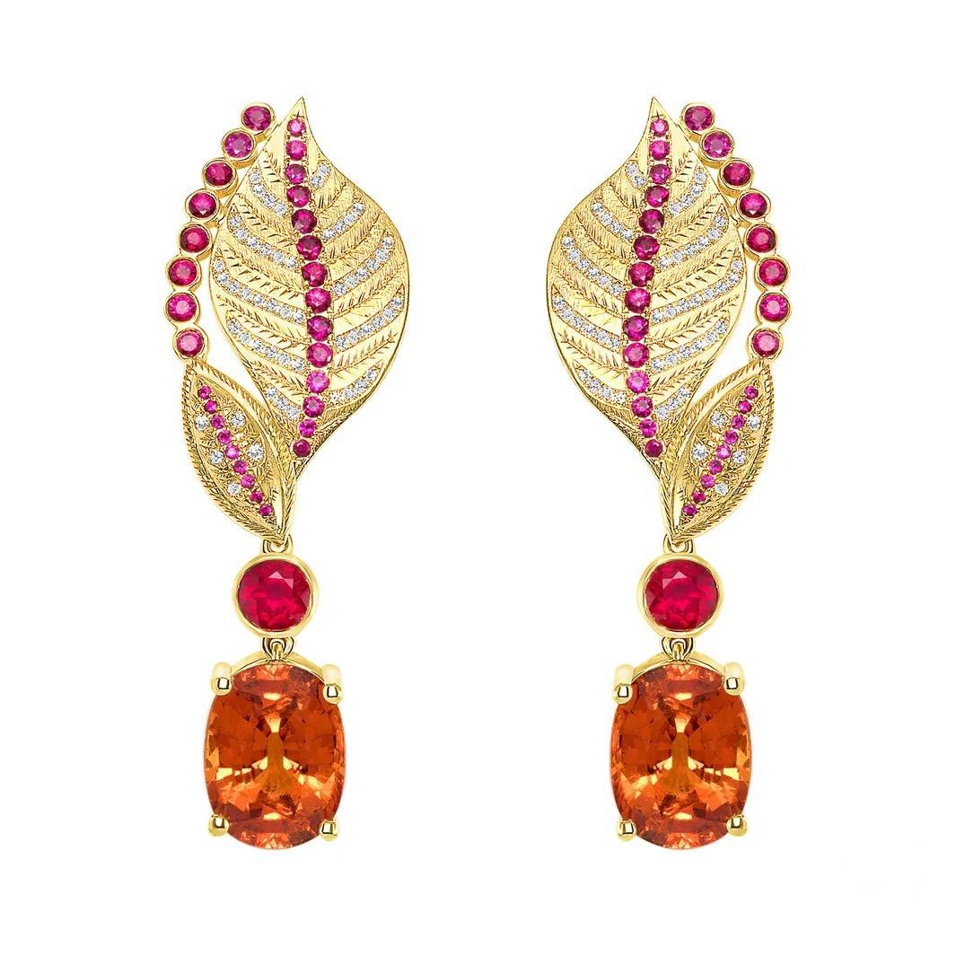 18K earrings, featuring two untreated Spessartite Garnets totaling 16.51 carats, complemented by numerous Rubies totaling 3.06 carats. These phenomenal gems are accented by 1.11 carats of white diamonds. Earrings are GIA certified. 