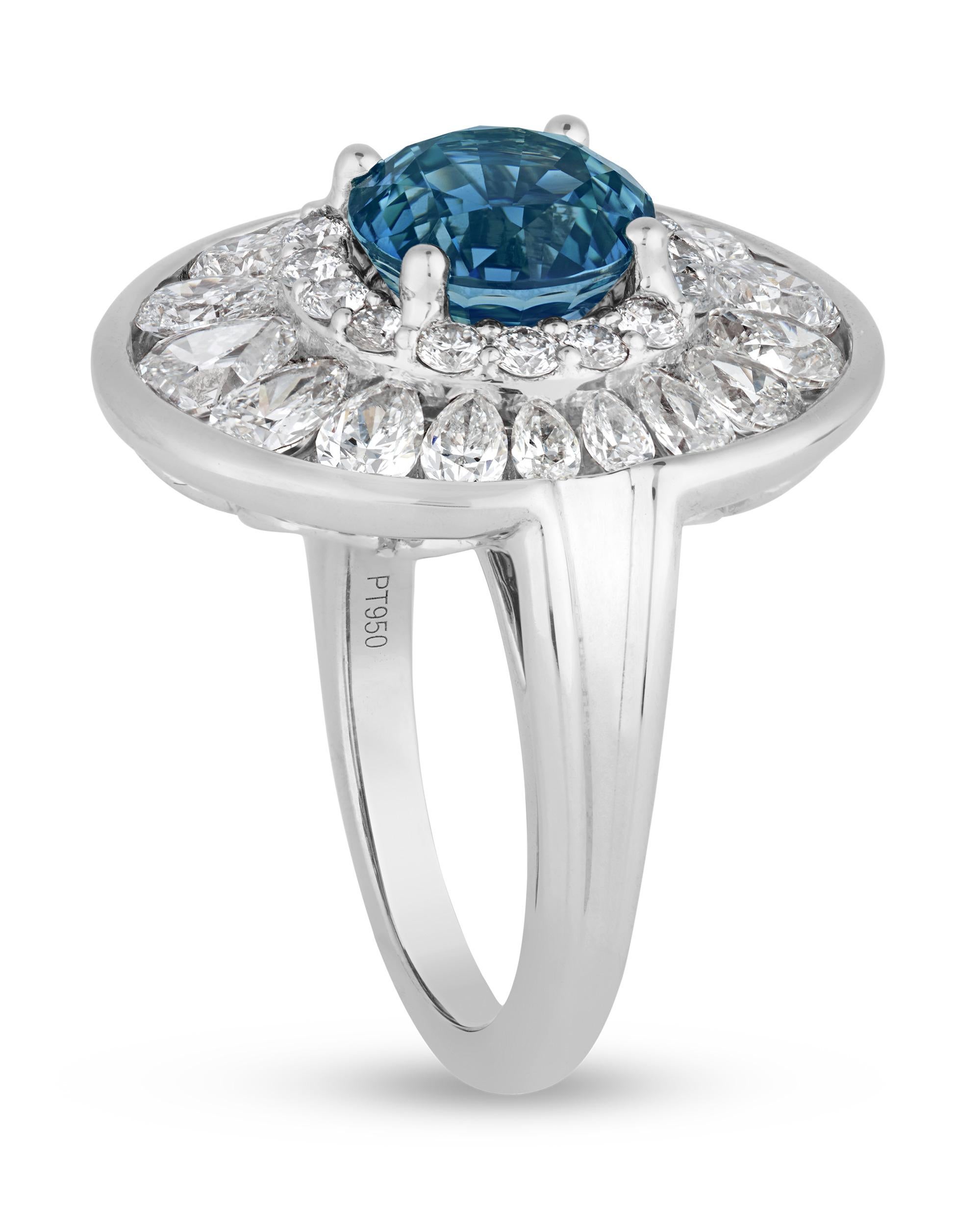 Displaying a captivating teal blue hue, the 4.03-carat brilliant-cut sapphire at the center of this ring dazzles on the finger. Certified by Bellerophon Gemlab, the sapphire shows no gemological evidence of heat treatments, meaning its bright