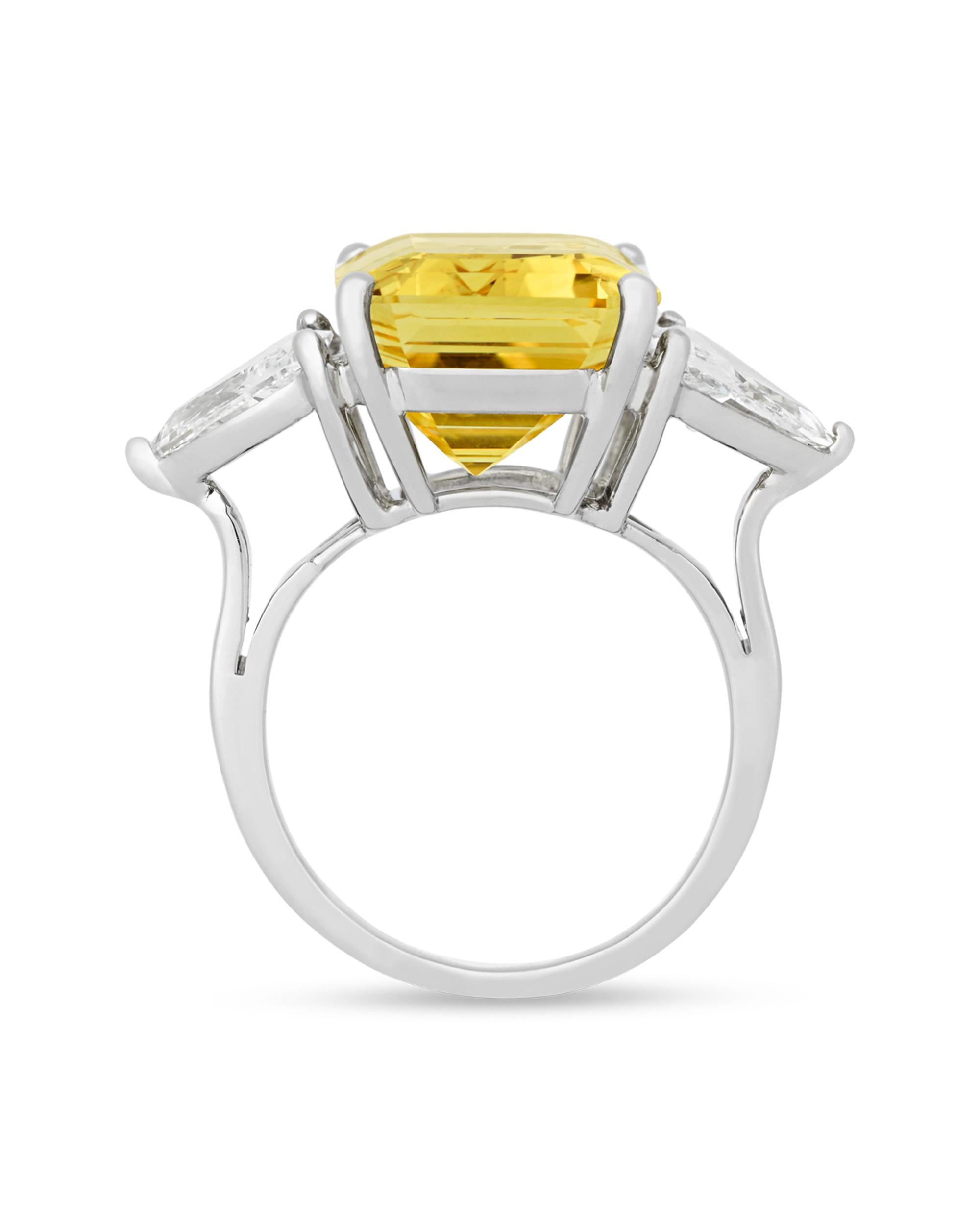 This classic ring features a fancy yellow Ceylon sapphire, one of the rarest of all fancy-colored sapphires. Weighing a monumental 17.82 carats, the rectangular emerald-cut jewel displays a superb yellow hue and is certified by the American