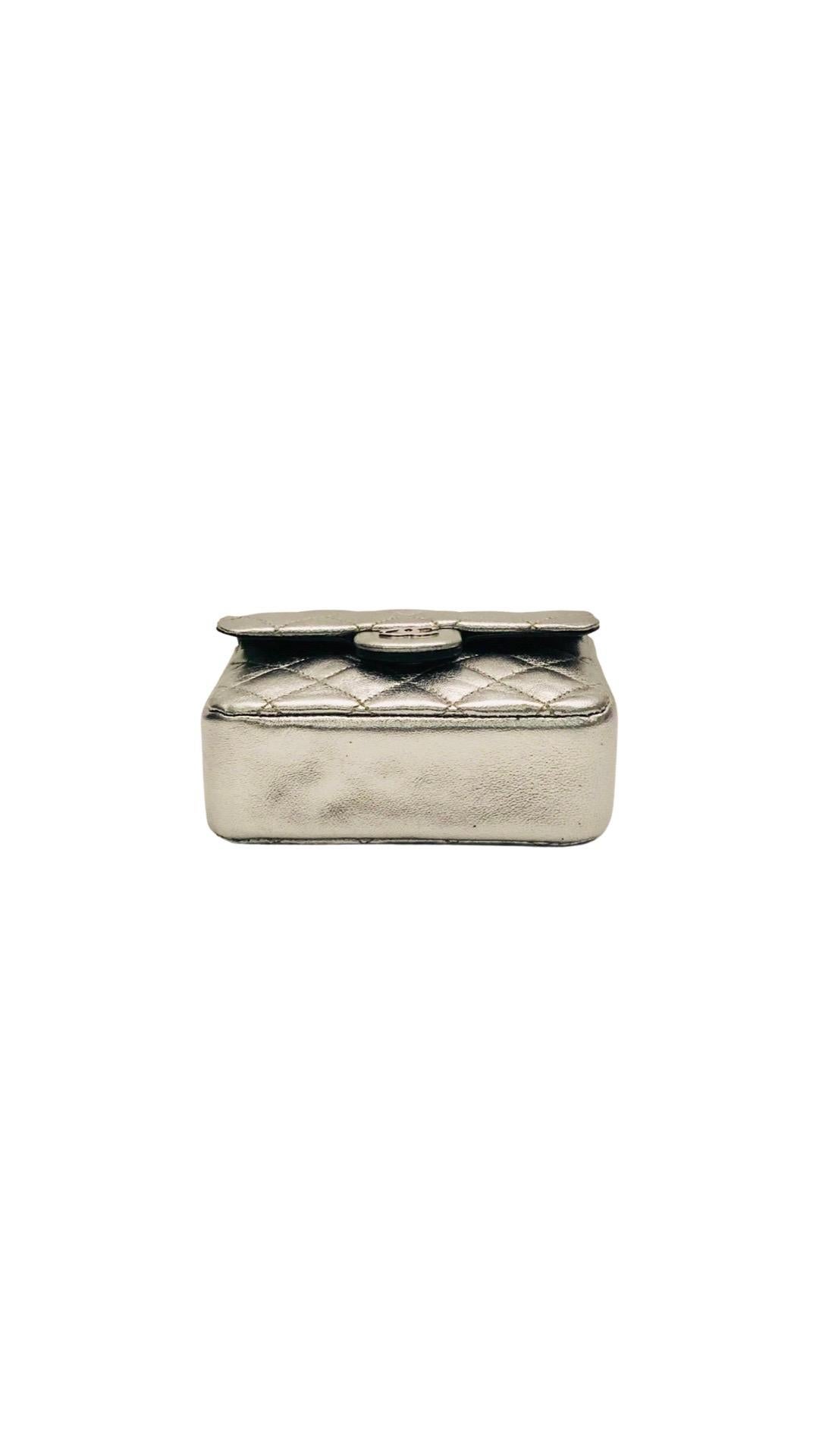 - Unused Vintage Chanel silver metallic leather micro mini chain belt bag from year 1997 to 1999 collection (Serial 5). 

- Flap and push button closure. 

- Length: 3.75 inches.
  Height: 3 inches. 
  Width: 1.5 inches. 
 
- Comes with authenticity