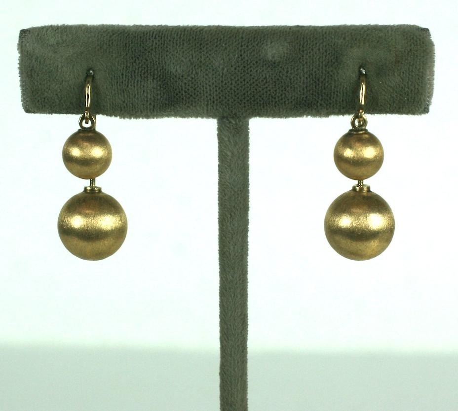 Cool and unusual 14k Gold Back to Front Ball Drop Earrings from the 1970's. Larger ball unscrews so one can insert earring. Can be worn with larger ball in back or front. Florentined gold balls hang at different levels. 
1