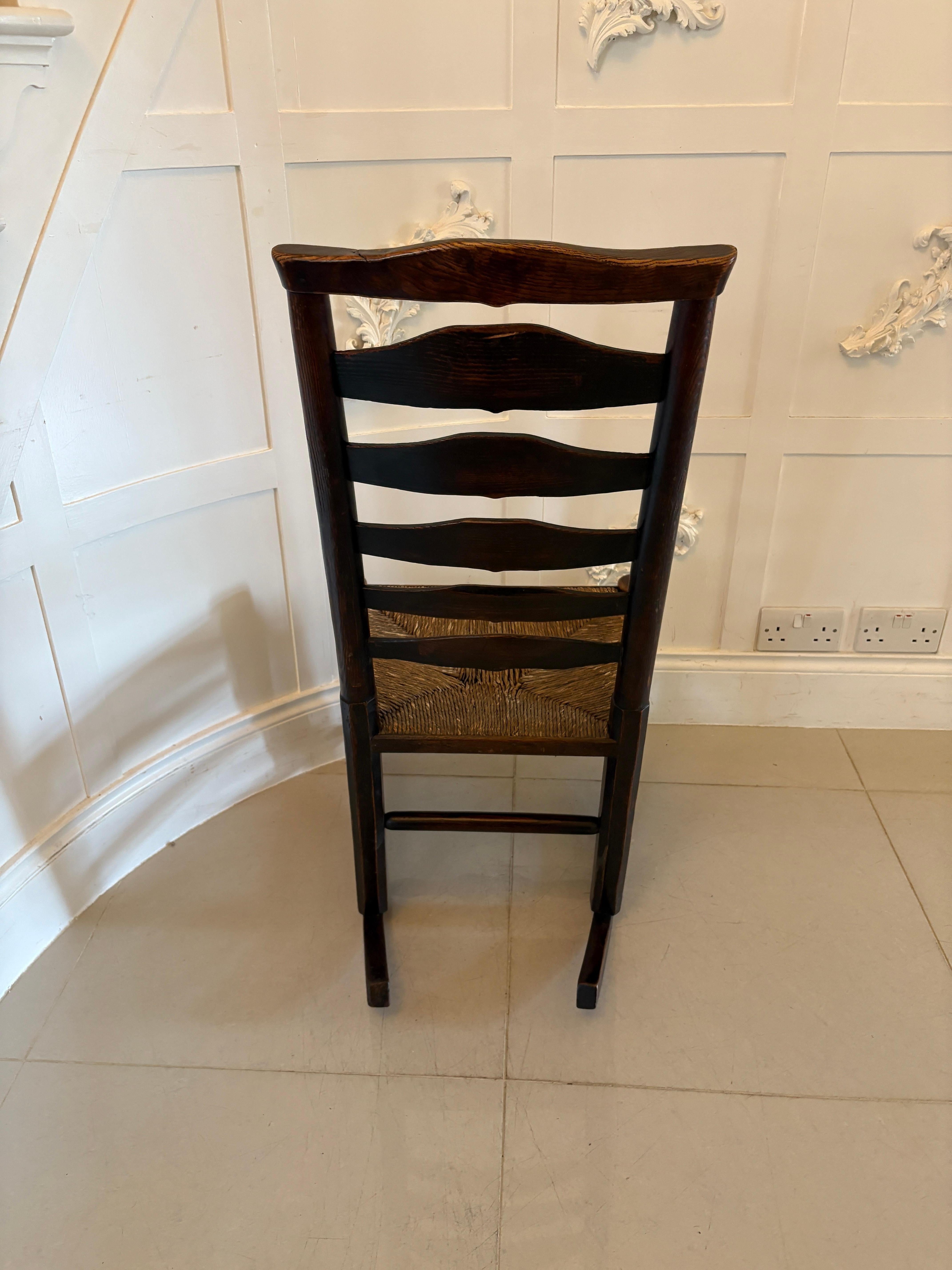 Unusual 18th century antique oak ladder back rocking chair having a ladder back with original rush seat, shaped pad feet to the front united by turned stretchers and raised on original rockers.

In lovely original condition

Dimensions:
Height 95.5