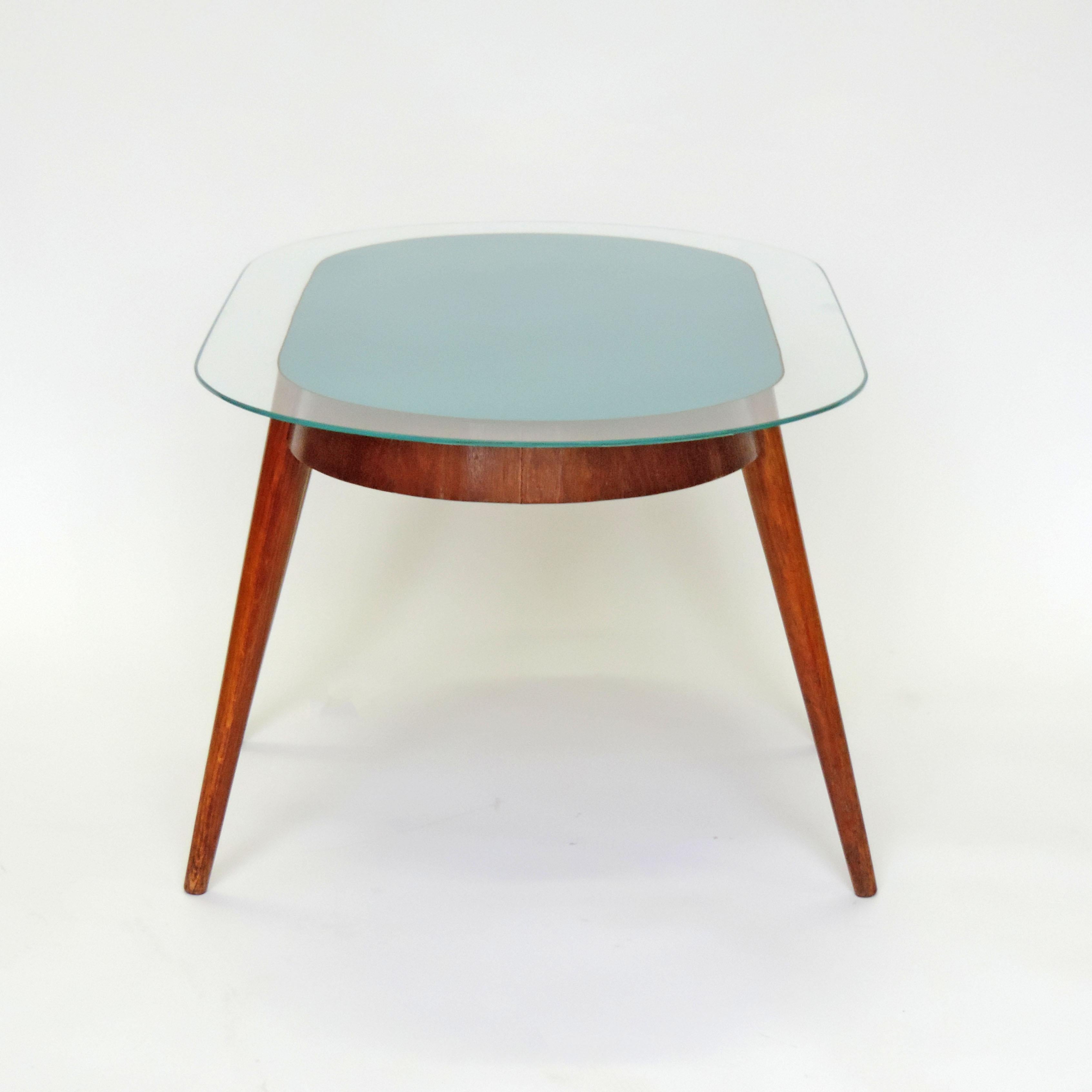 Unusual 1950s Italian coffee table in wood and light blue reverse painted glass.
