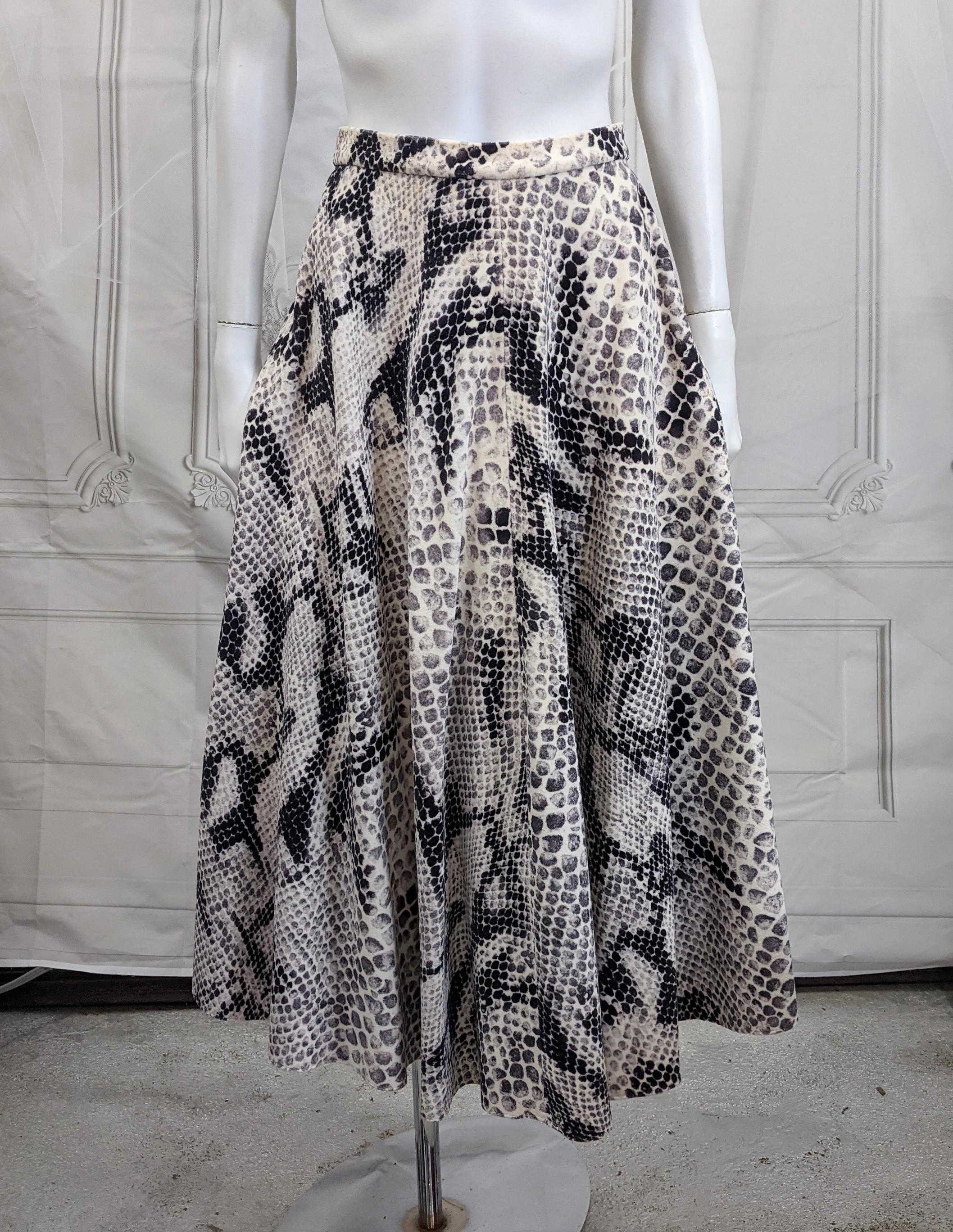 Unusual 1950s circle skirt of grey and black toned snake skin printed ivory cotton velvet. Back zip entry.
Length 31