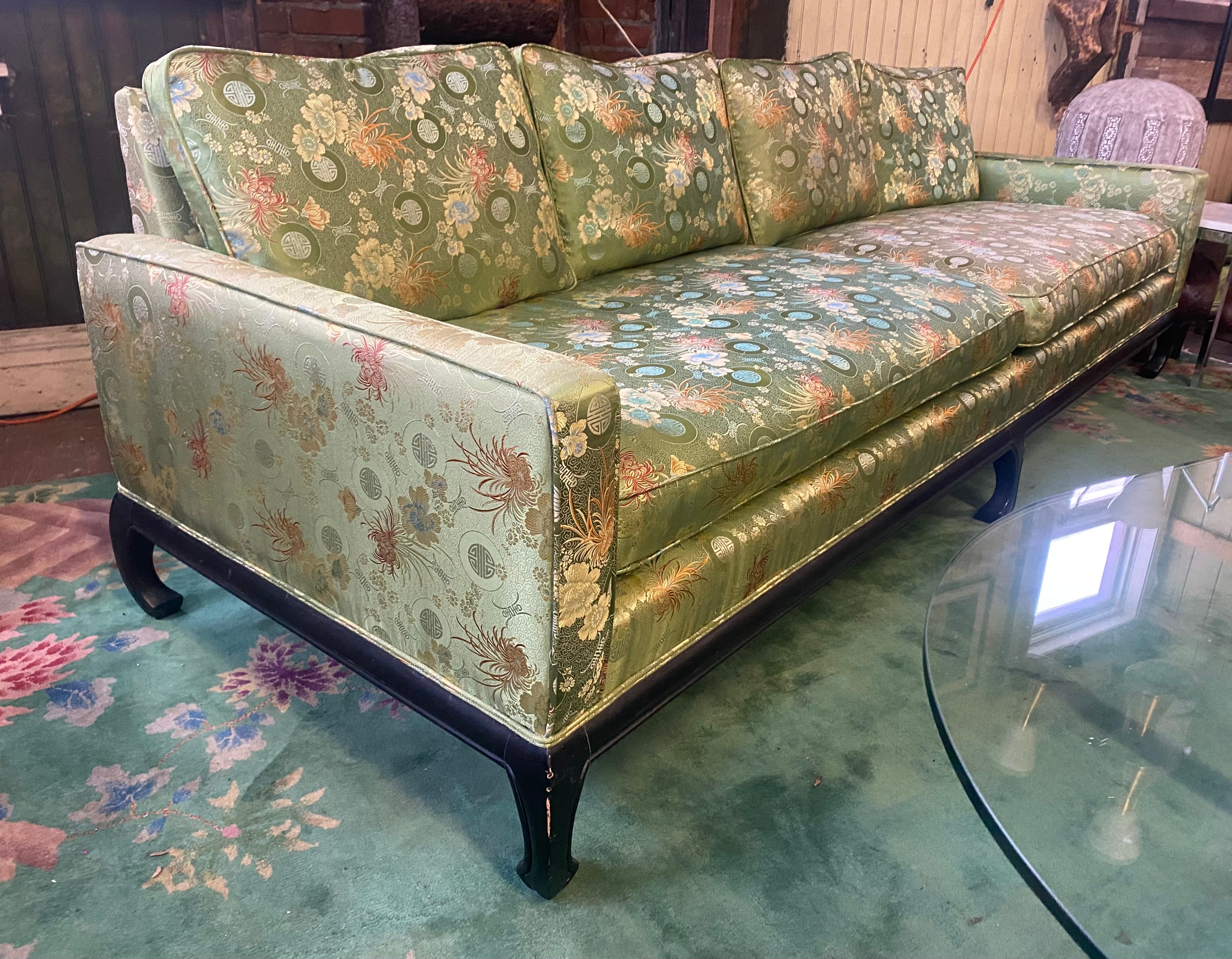 Stunning Asian James Mont style sofa with black lacquer base, circa 1960s. This wonderful sofa also has lovely Chow style legs,. Retains its original silk upholstery. Stunning color, pattern, design. Also retains ts original down filled cushions,