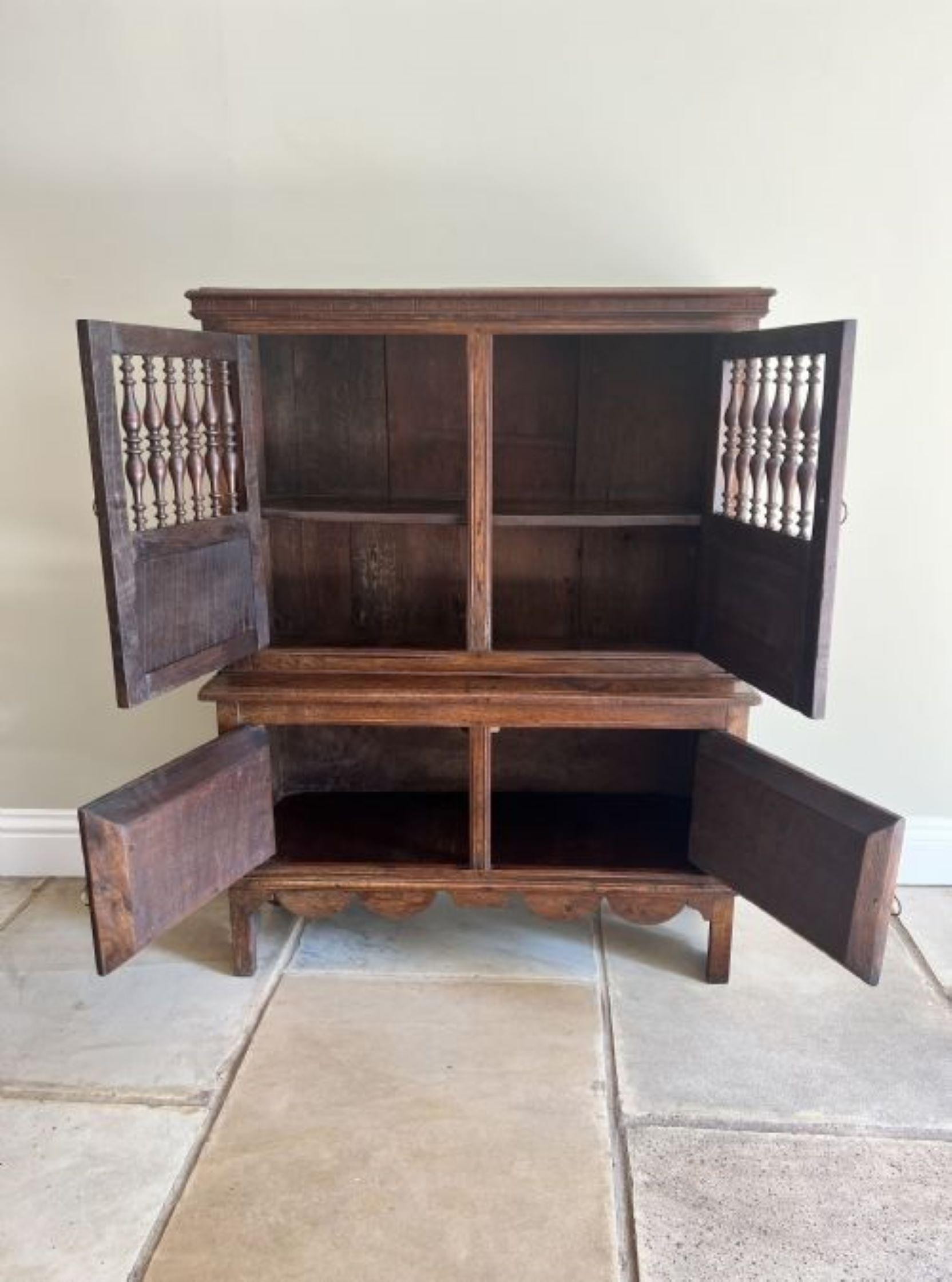Unusual 19th Century antique quality oak food cupboard having a polished oak rectangular shaped top above a pair of carved oak doors with quality turned oak spindles opening to reveal a storage compartment above a cupboard base with a pair of carved