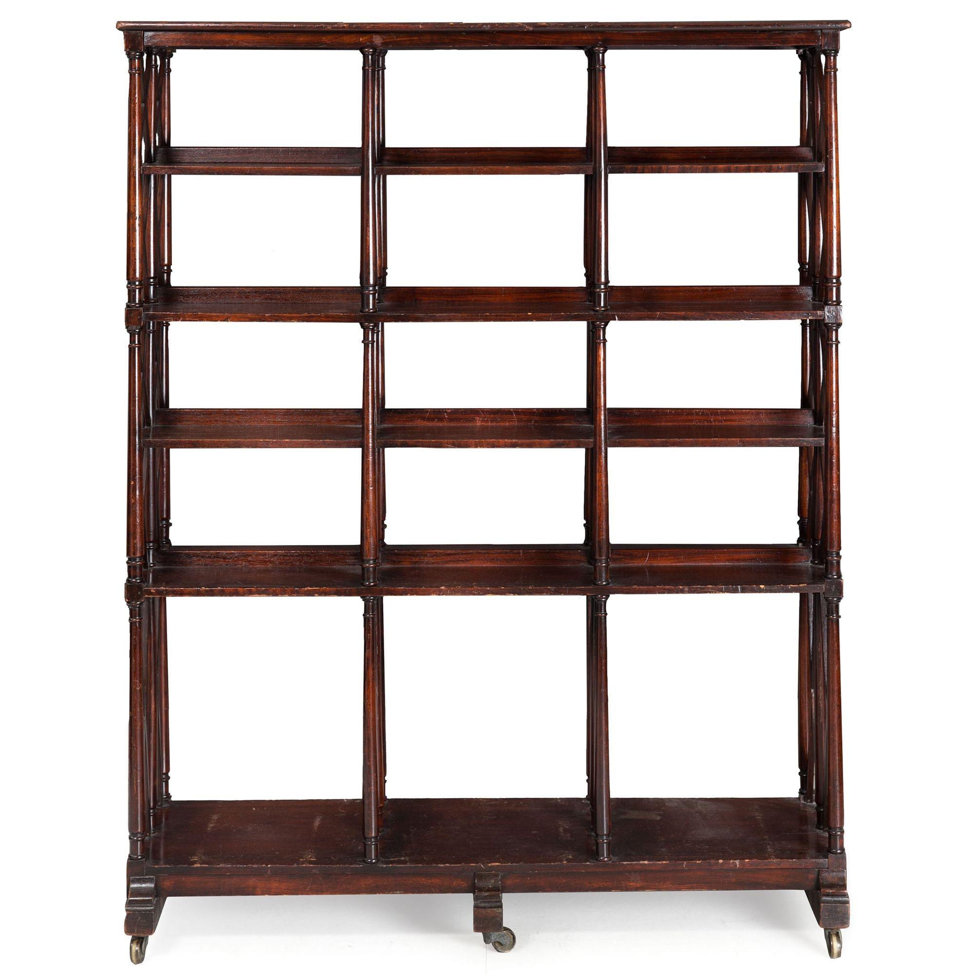 UNUSUAL VICTORIAN MAHOGANY DOUBLE-SIDED BOOKCASE
England, circa mid-to-late 19th century
Item # 209APB28Q 

This uncommon double-sided bookcase is composed of a complex array of latticework that lends the needed strength and angular support to the