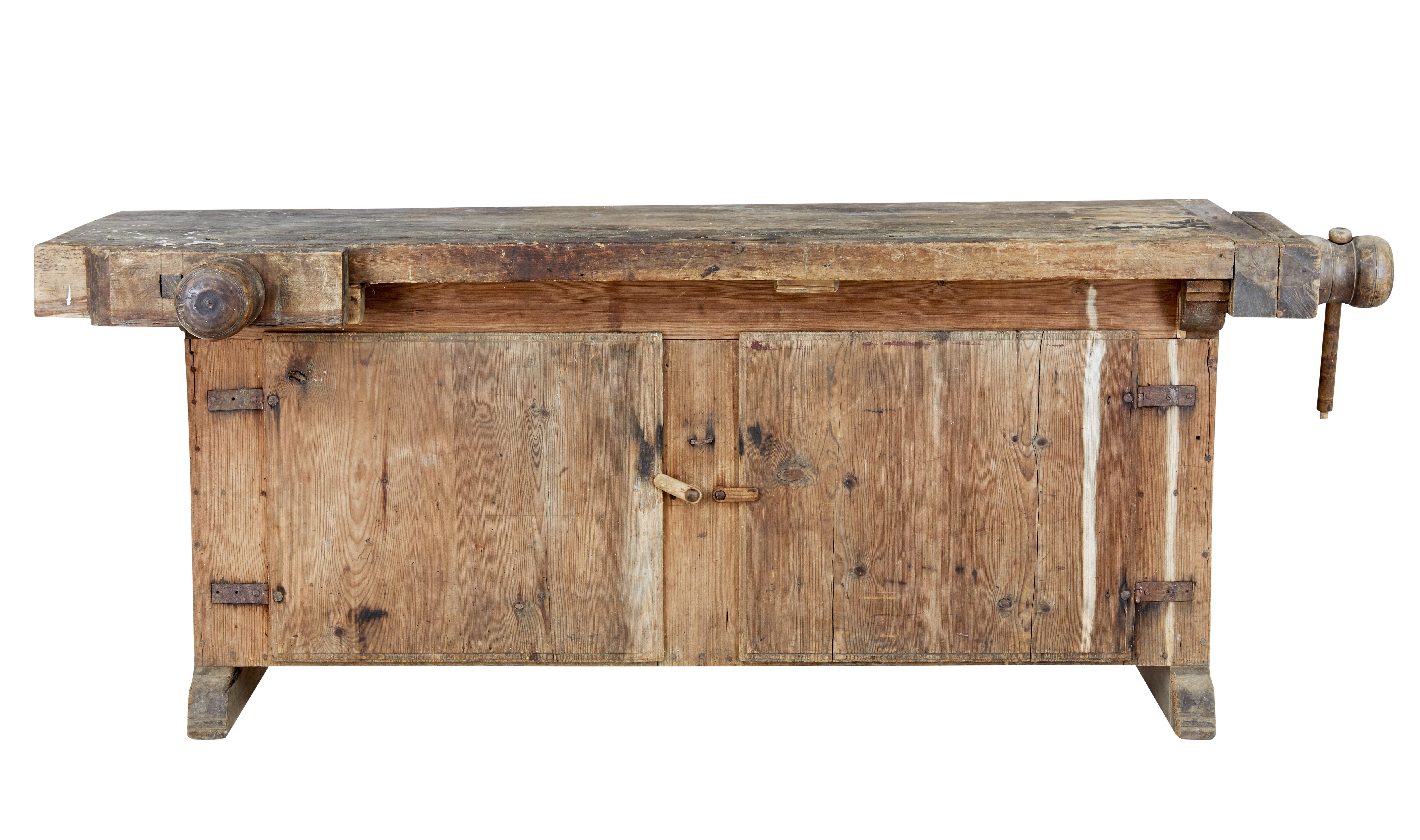 Unusual 19th century pine sideboard workbench, circa 1880.

Fantastic opportunity to own a rustic workbench and become a unique installation sideboard. Double clamp workbench with clamps to the front and side.

Top sits on a cupboard base,