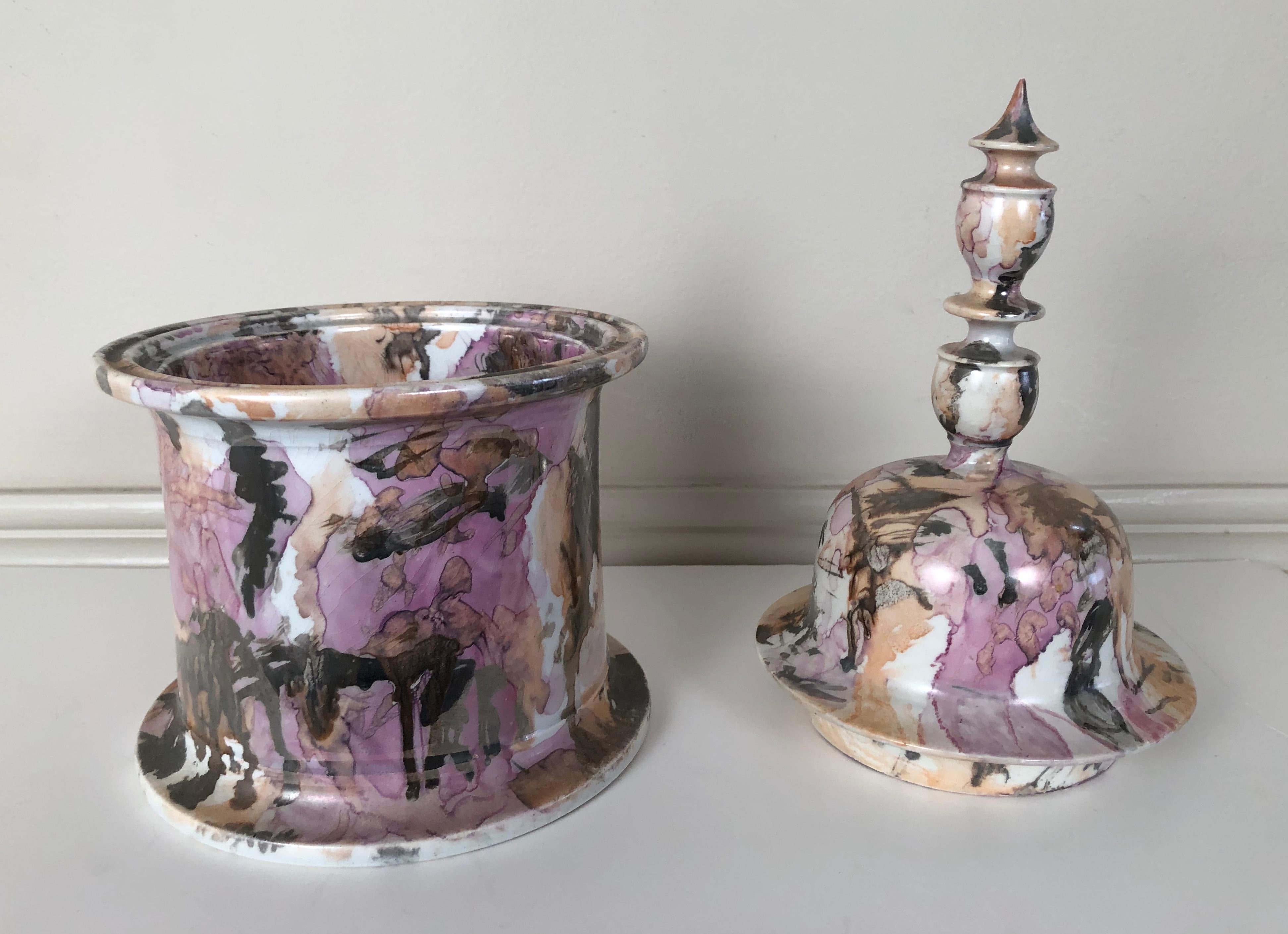 An unusual 19th century English pink lustreware Staffordshire pottery covered vessel,  the domed top with a tall, elaborate urn shaped finial over a circular base with reeded flared rim and spreading foot, decorated overall with a wonderfully