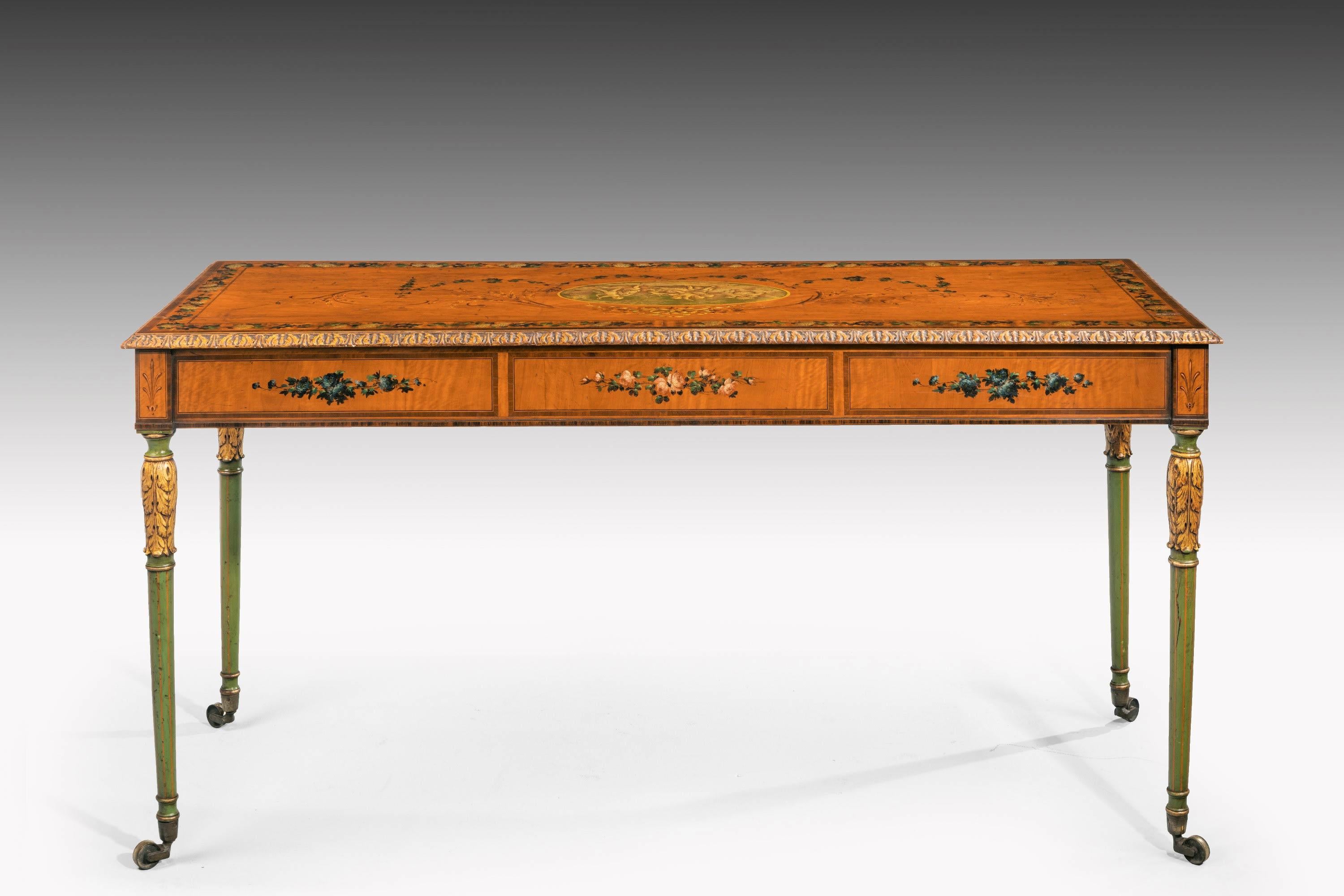 A most unusual 19th century slender, satinwood, centre standing table with finely painted and gilded decoration. The supports of a soft green hue, now well faded. Original shoes and castors and quite splendid side carrying handles.
     