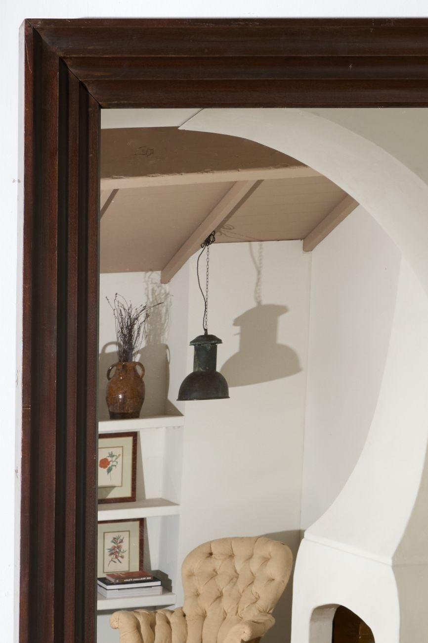 This is a striking mid 20th century African hardwood mirror. The thickness of the solid timber is fabulous and the mirror weighs over 20kg!. Hugely impressive design with a lovely design that will work well in a number of interiors. The colour of