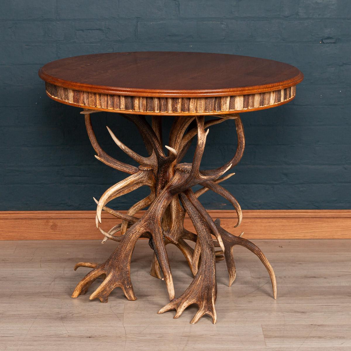 An extremely unusual mid-20th century centre table by Anthony Redmile. The side of the table profusely decorated with sections of antler horn and the table leg fashioned from whole antlers. The British designer Anthony Redmile was known in the 1960s