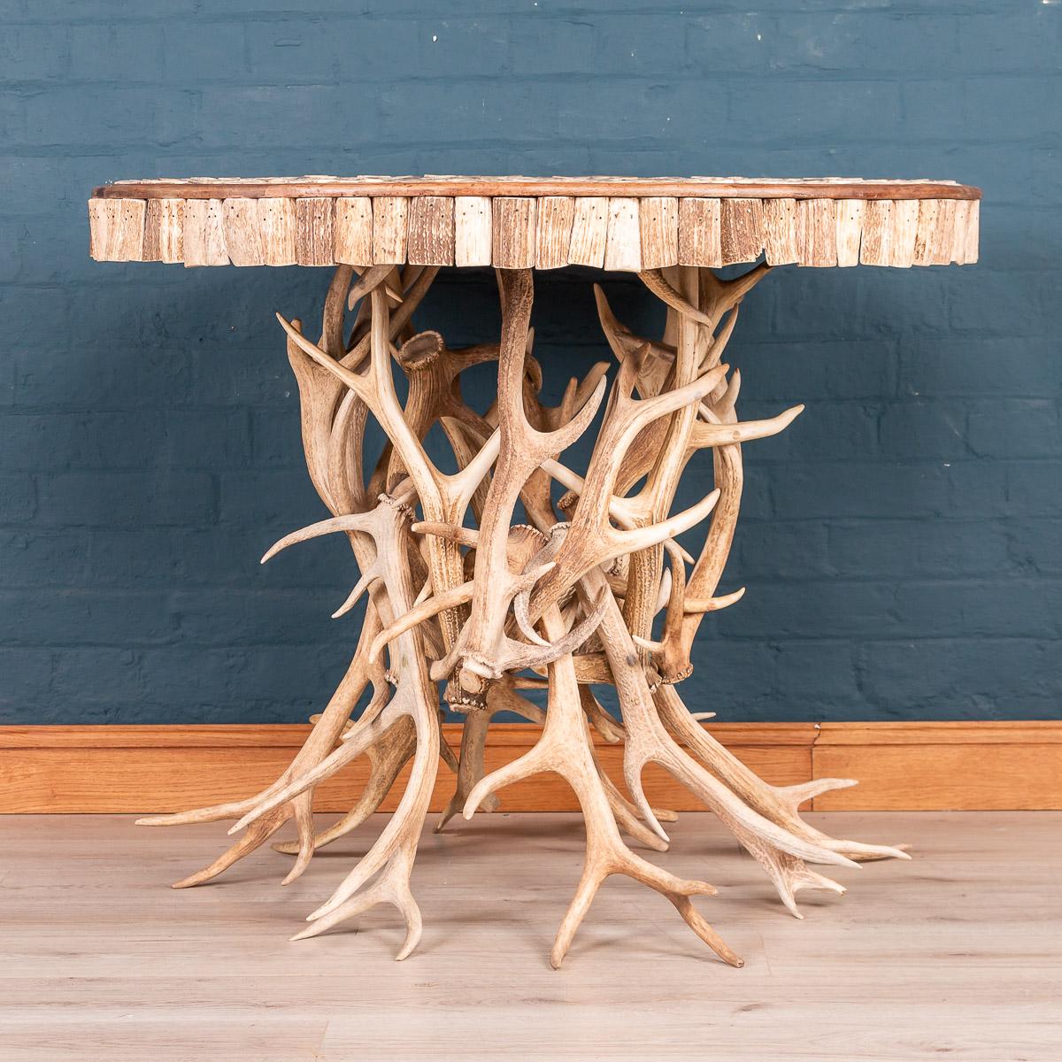 Extremely unusual mid-20th century centre table in the manner of Anthony Redmile. The table top profusely decorated with sections of antler horn and the table leg fashioned from whole antlers. 

Condition:
In great condition - No damage, just