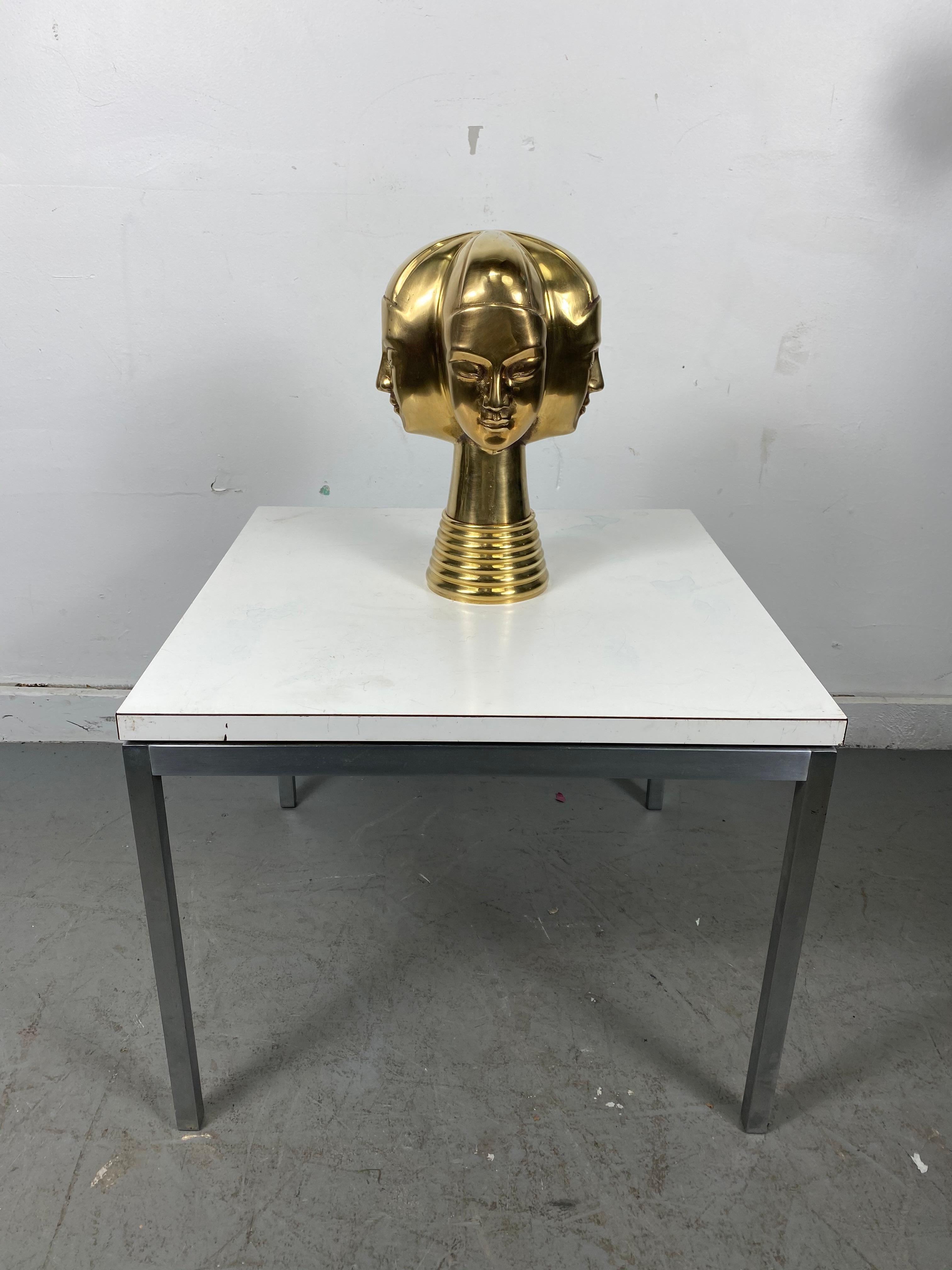 Unusual 4-head modernist brass sculpture by Dolbi Cashier....Egyptian, Art Deco design, retains original label.