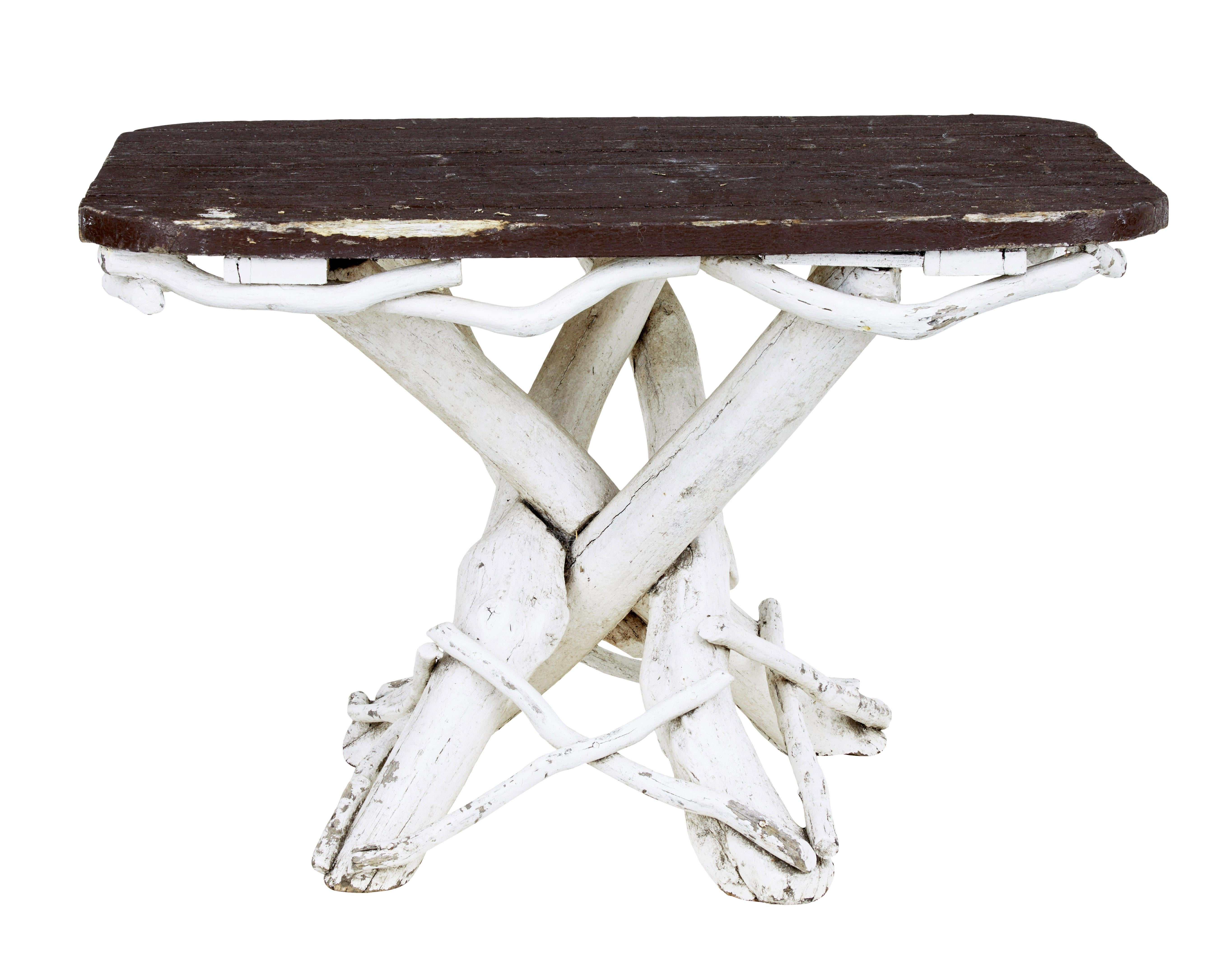 Unusual 5 piece painted natural wood garden set circa 1940.

Rustic piece of Swedish wood work using sourced branches to make furniture.  Set comprises of a table, sofa, 2 armchairs and a stool.

Table with crossover legs and painted pine top.  Sofa