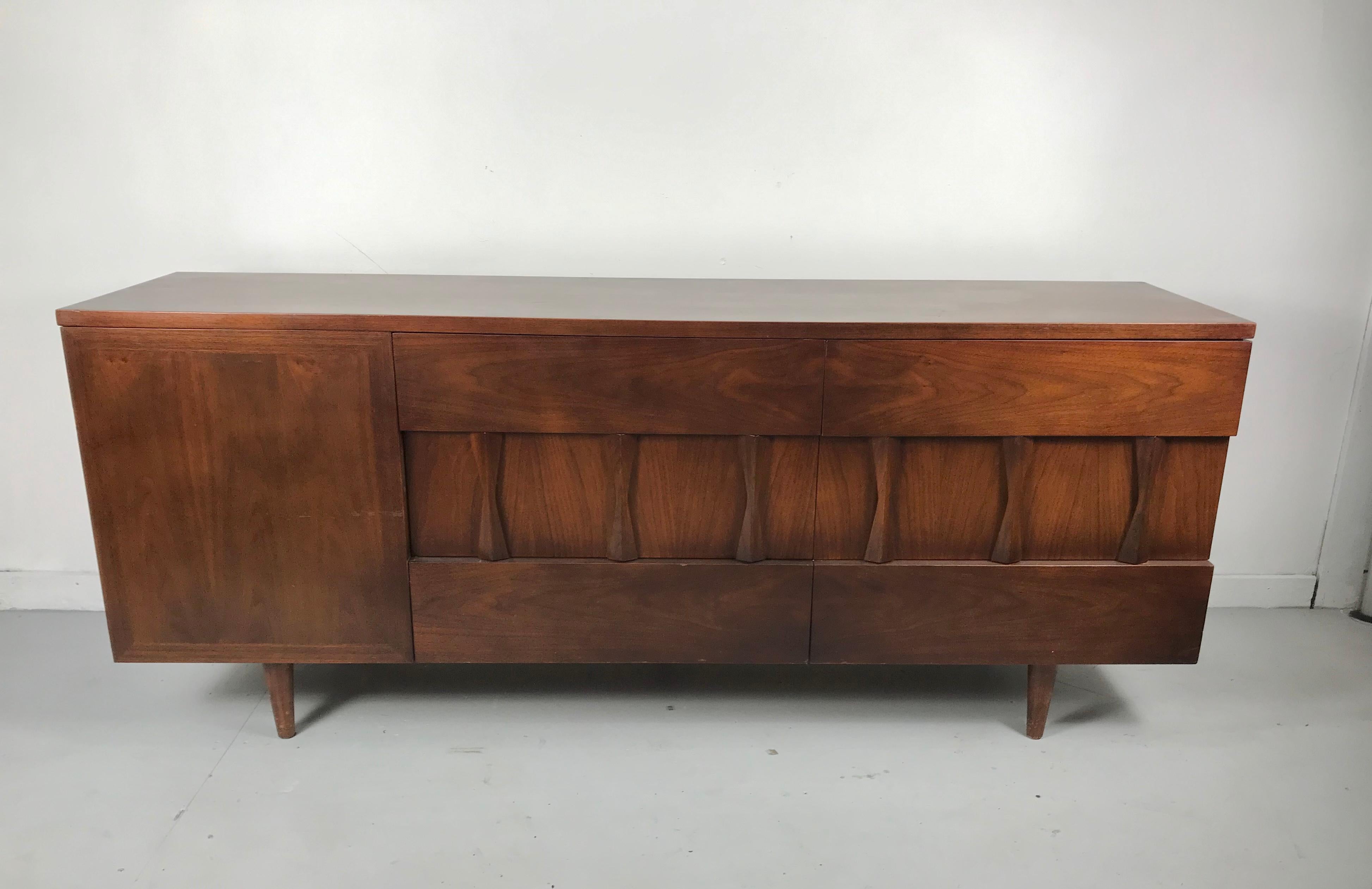 Unusual 9-drawer dresser, sculpted walnut made by American of Martinsville. Amazing architectural design. Over 30 years in the business, i have never come across this line. Featuring 6 generous size drawers with stunning sculpted pulls, left side