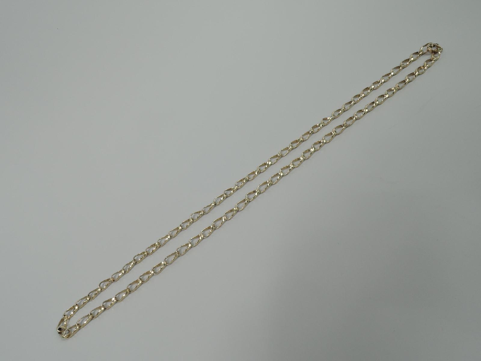 Unusual 14k gold chain necklace, comprising faceted oval links. No clasp. Custom made. United States, ca 1980s.