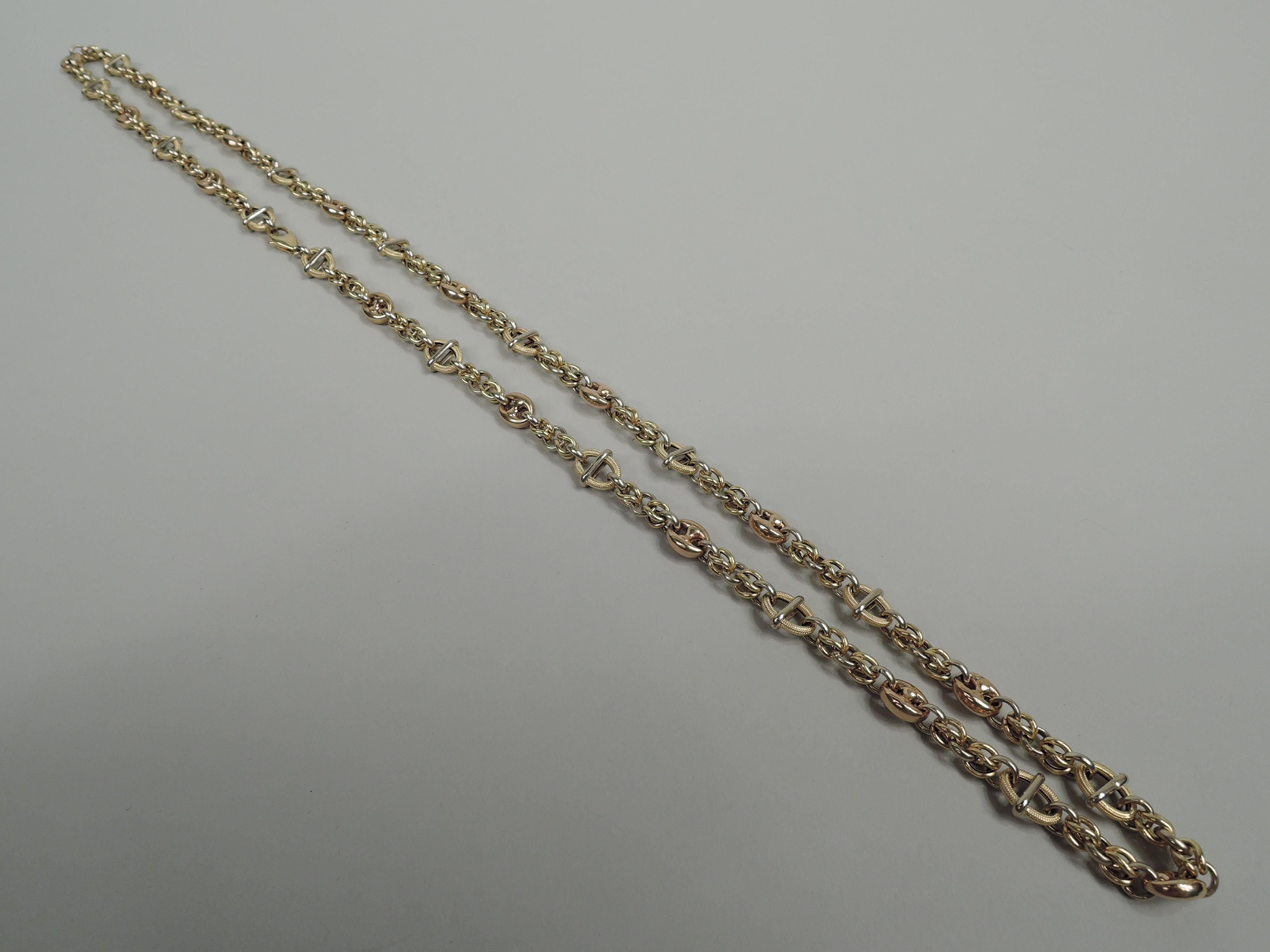 Unusual American Modern 18k gold chain, ca 1980. Small yellow gold links interspersed with large tooled ovals with central wraparound band as well as thick and solid rose ovals. With clasp.