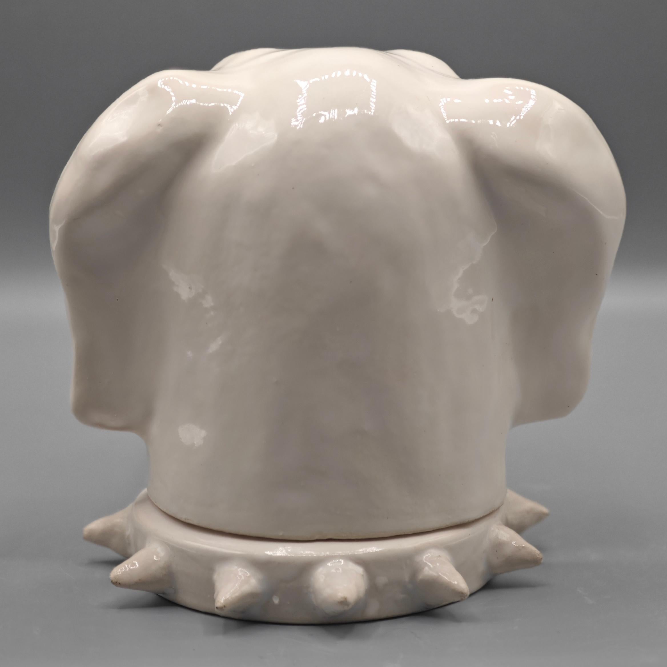 A unusual and decorative box, 
The lid representing a hound’s head, fitting on top of a spiked collar base.
White glazed ceramic. 

Jean Roger, France circa 1965 
Signed  J.Roger. Paris 
H: 12.5 cm/ 4.9
