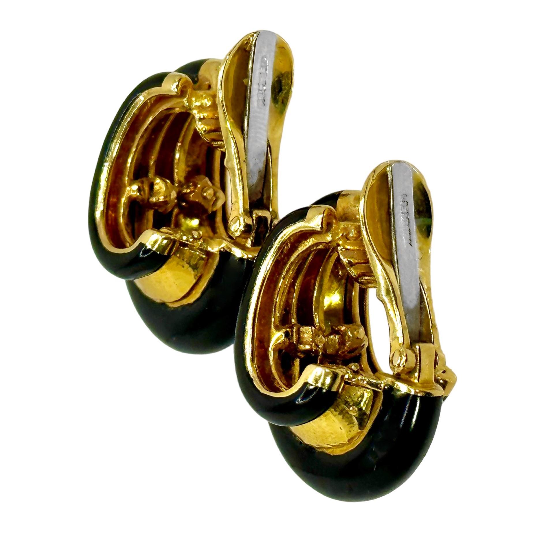 This striking pair of Mid-20th Century 18k yellow gold and shining black enamel David Webb designer hoop earrings are an unusual and not often seen design. Three broad bombe bands of black enamel radiate out towards the bottom and are separated by