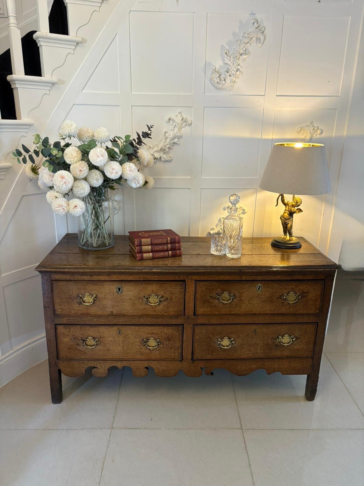 Unusual antique 18th century quality oak dresser base having a quality oak rectangle shaped top with a moulded edge above four oak lined cockbeeded drawers with brass handles standing on square legs united by a shaped apron.

A handsome 18th century