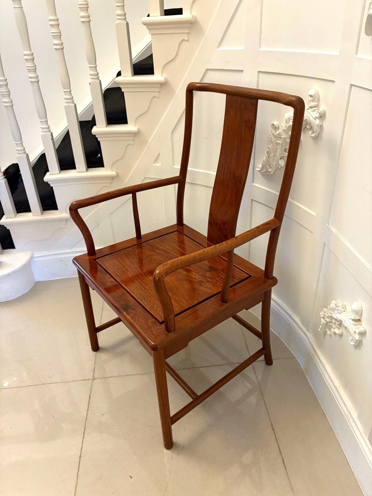 Unusual antique hardwood Chinese armchair having a delightful design with a shaped centre splat to the back and elegant shaped open arms with a hardwood seat raised on turned legs united by stretchers.  

A splendid example boasting a superior