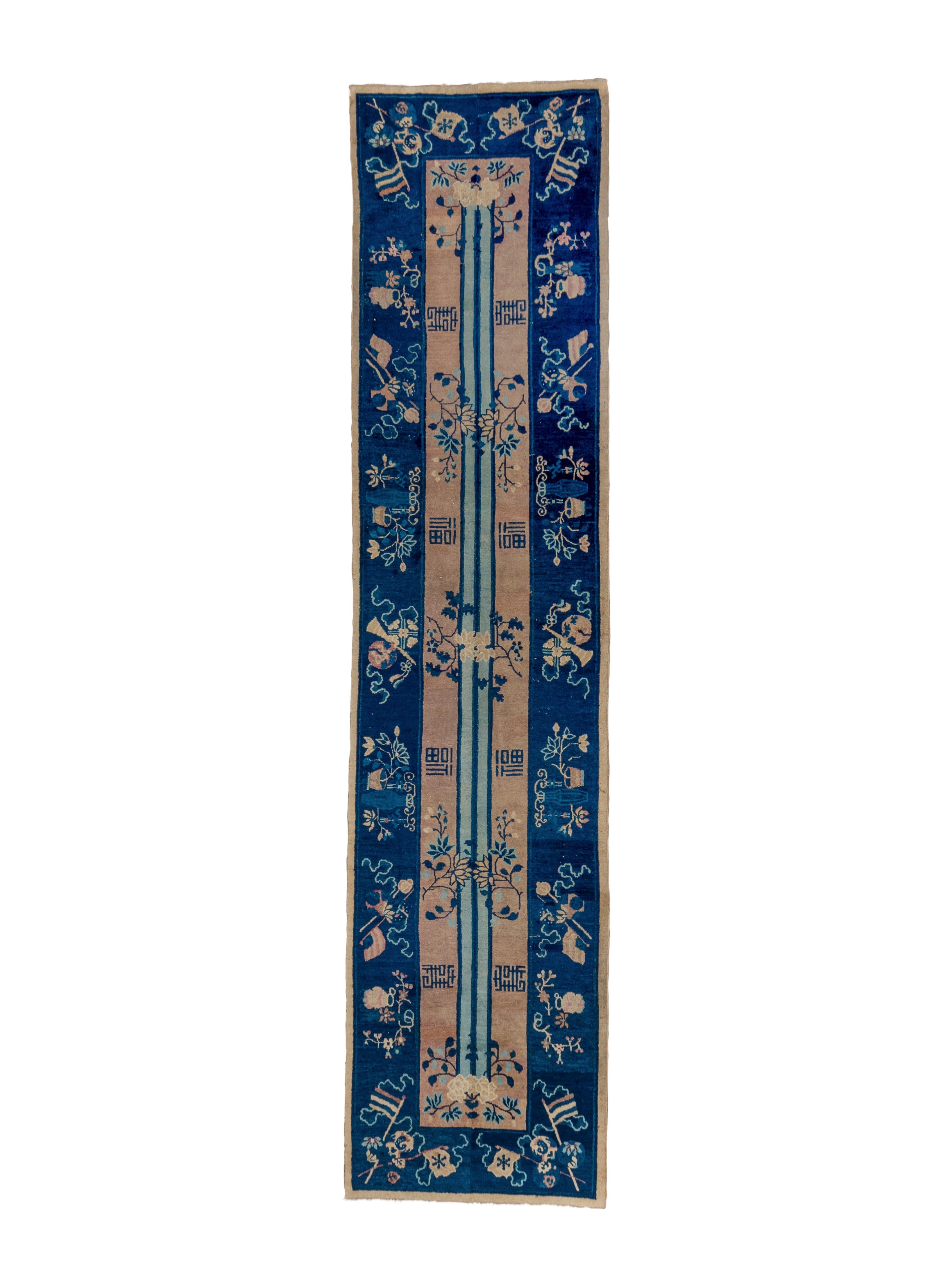 This very unusual runner shows a straw field with  a full length doubled column and lateral bits of Chinese calligraphy  and wrapping floral sprays.  The column seems to visually elongate the piece. Dark blue border with vases, trumpets, flags,