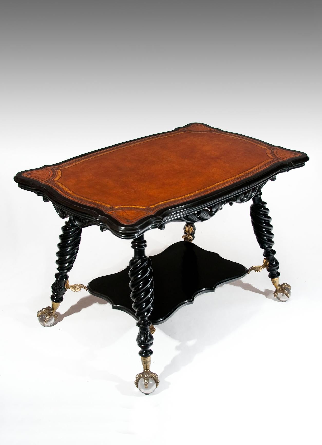 A quality and rare antique ebonized centre table.
The shaped top having a tan leather insert which is gilt and blind tooled with a neat small banding and central decorative shaped carving is supported by four turned and carved ebonized legs united