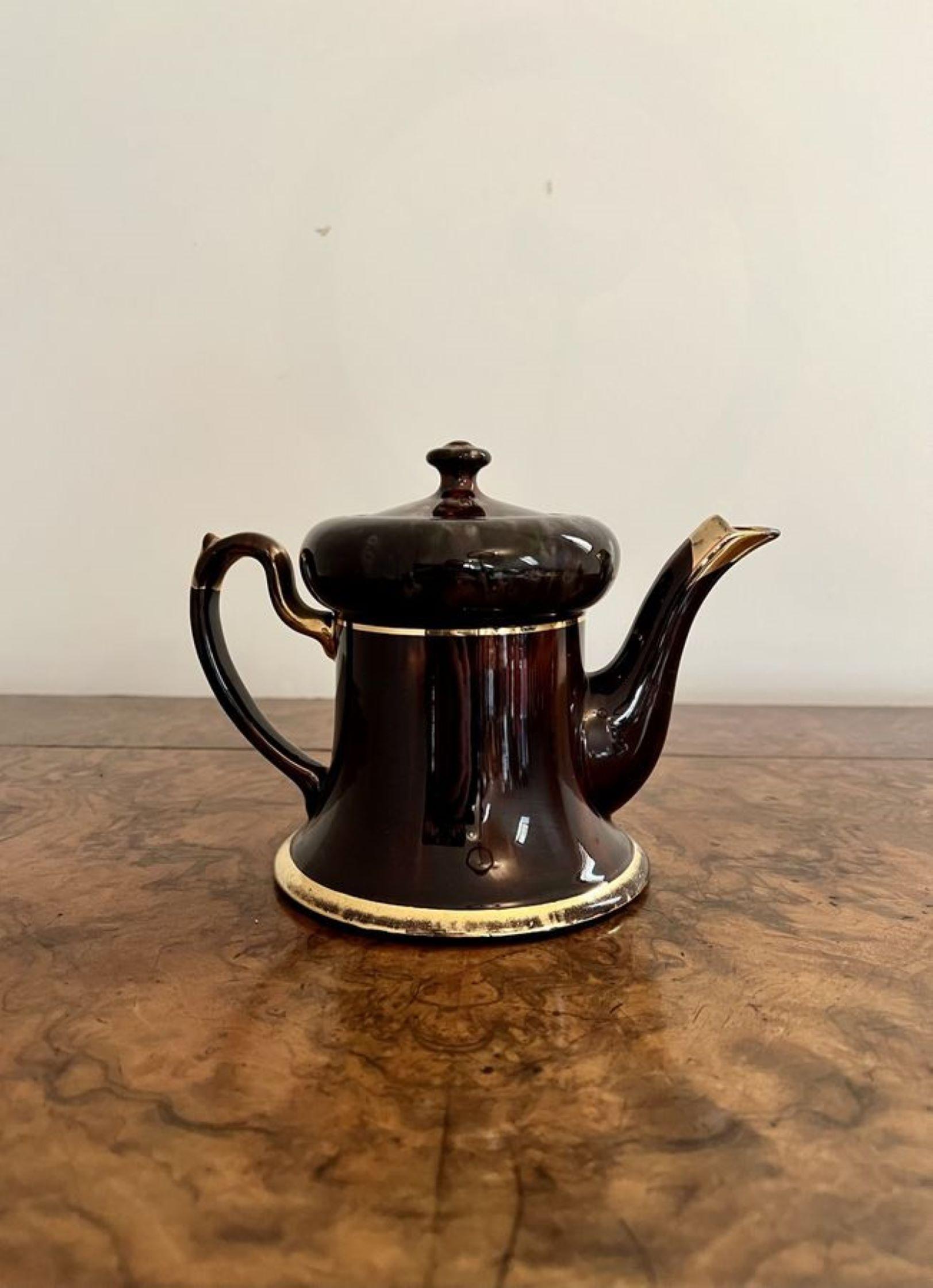 Unusual antique Edwardian glazed brown & gold teapot having a quality brown glazed and gold teapot with a shaped handle and spout with the original lid.

D. 1900