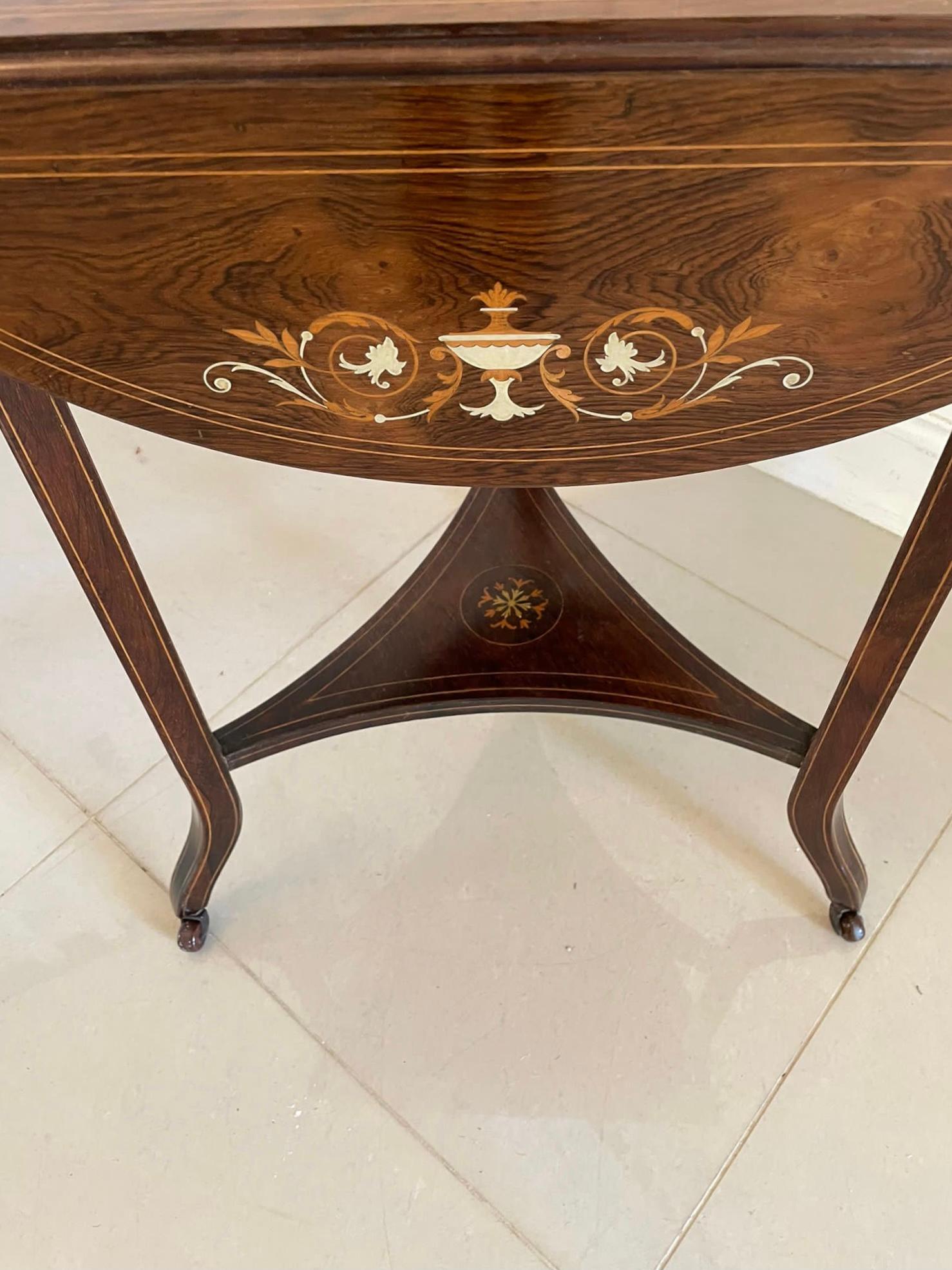 Unusual antique Edwardian quality rosewood inlaid drop leaf centre table having a quality attractive rosewood inlaid top with three shaped rosewood prettily inlaid drop leaves supported by three square tapering inlaid legs with shaped feet united by