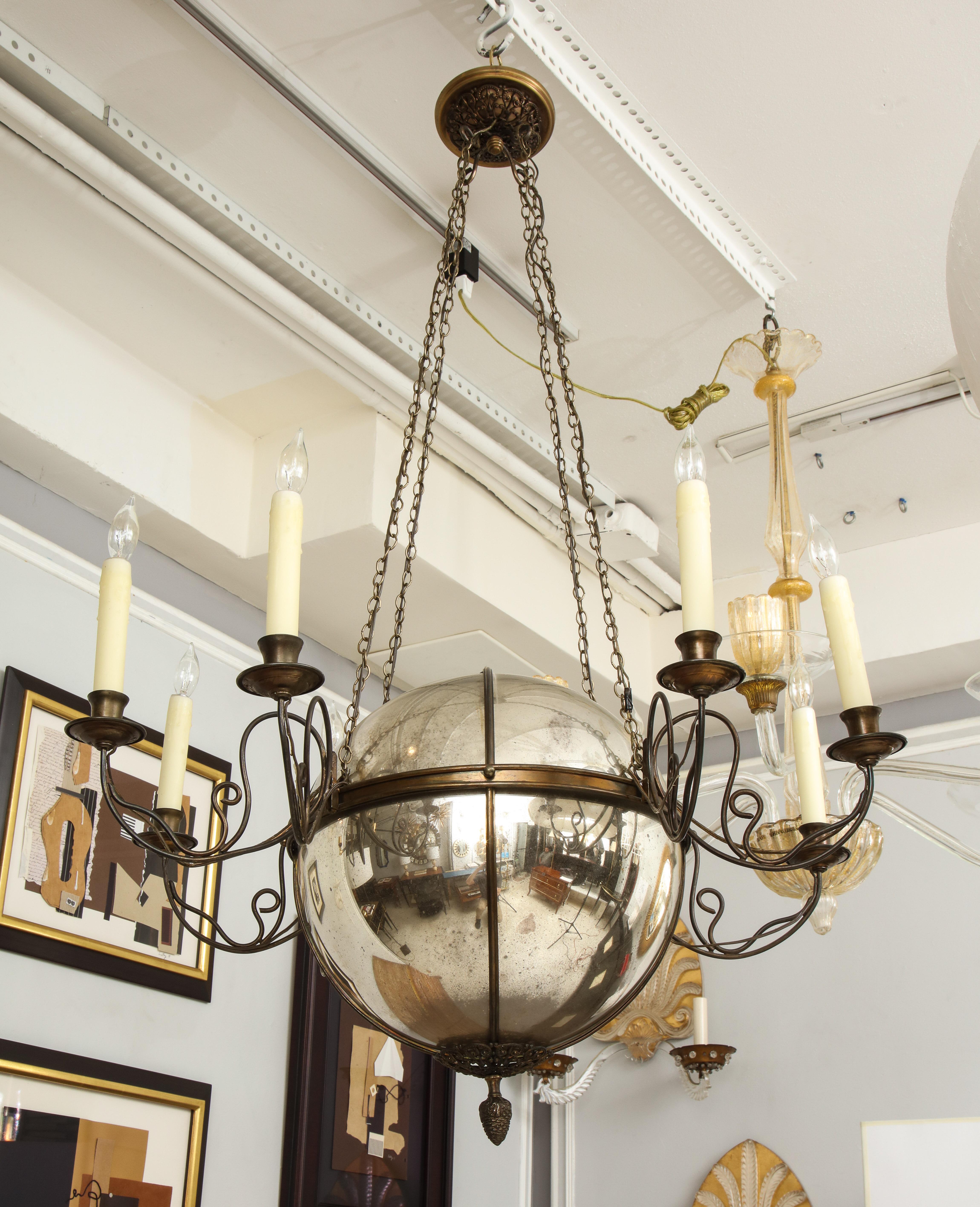Unusual antique eight-light brass chandelier with a central mercury glass orb.