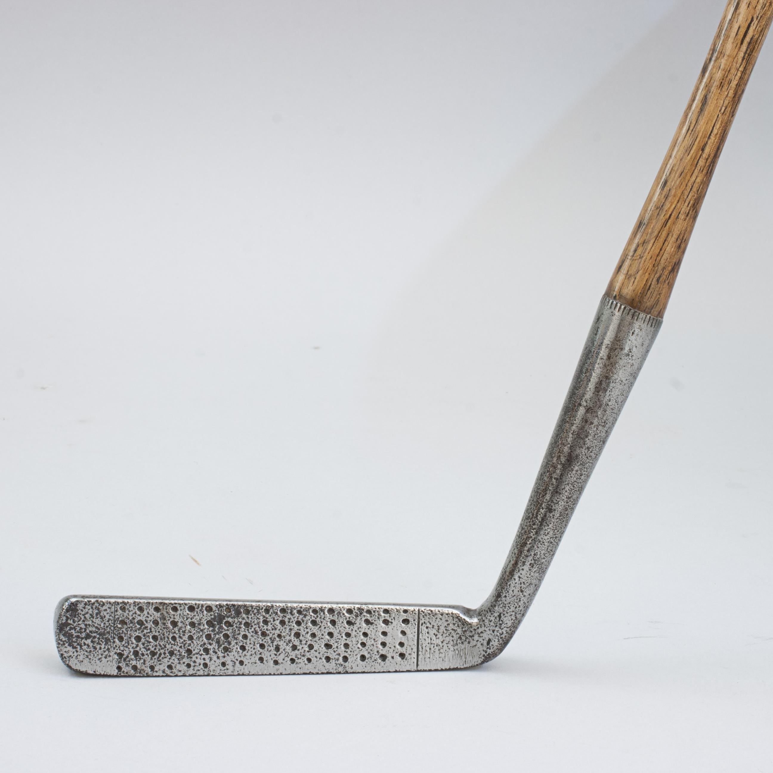 Unusually Long Faced Blade Putter, Frank
An early, slightly offset, wry neck blade putter with an unusually narrow and long club head. The back of the club head is rounded with very indistinct markings, 'Frank, Hand Forged' possibly with three
