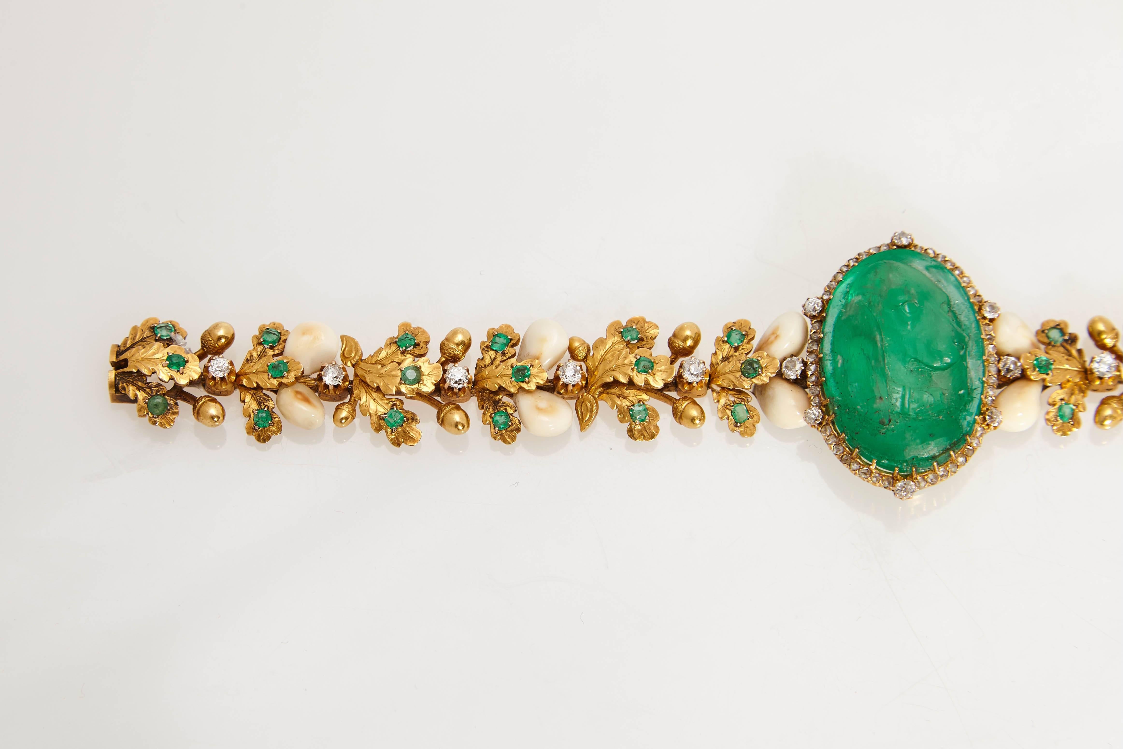 A very unusual bracelet in celebration of hunting, centering an emerald cameo representing a dog, the body of the bracelet composed of gold leaves and wild boar teeth, highlighted with diamonds and emeralds. Made in Italy, circa 1910.