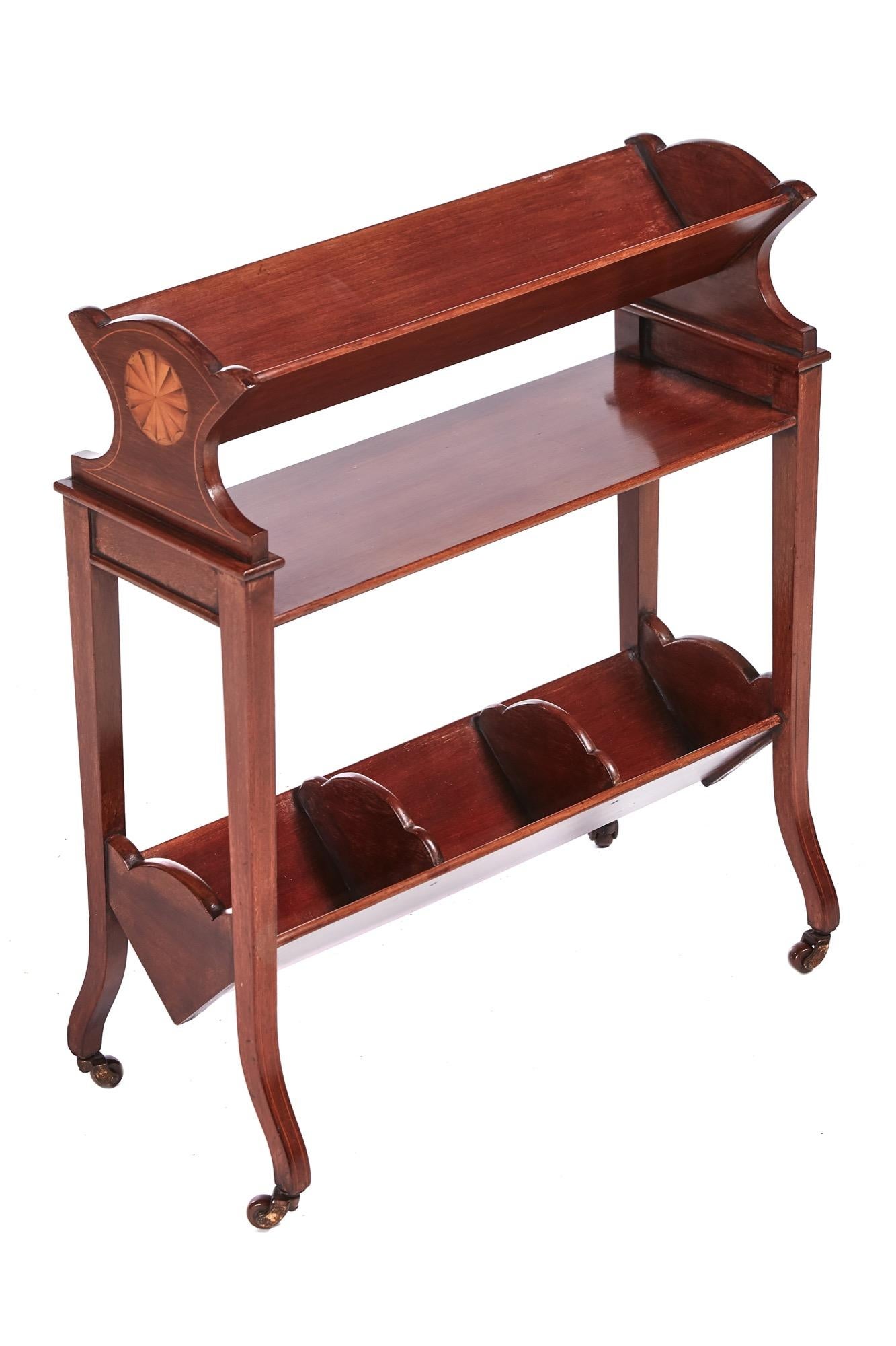 Unusual antique mahogany inlaid book trough with two book troughs one shelf, lovely shaped ends, standing on original castors.
Lovely color and condition.
Measures: 21