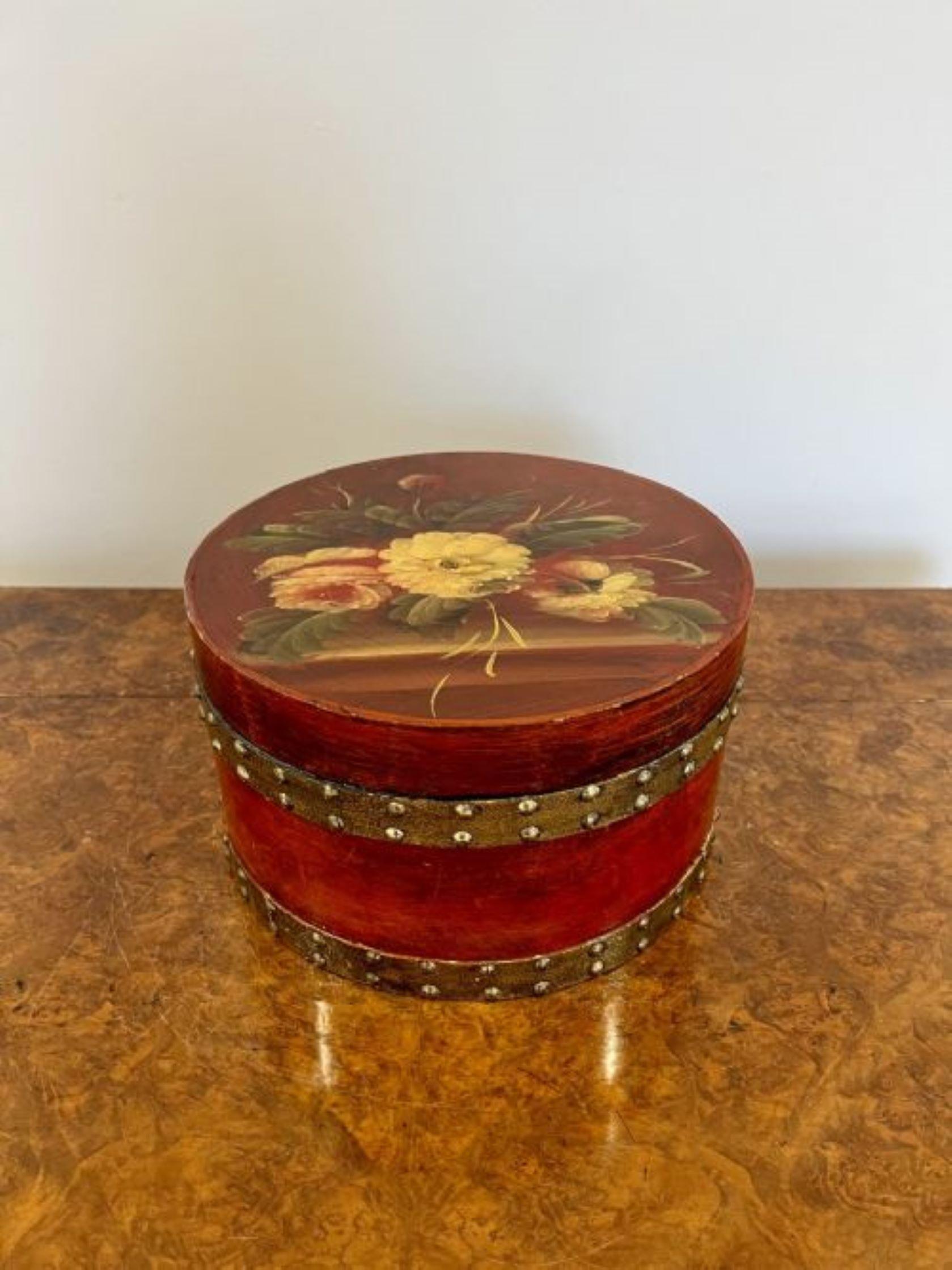 Unusual antique pair of hand painted circular storage boxes having an unusual pair of circular storage boxes hand painted in floral decoration in wonderful red, green and yellow colours 