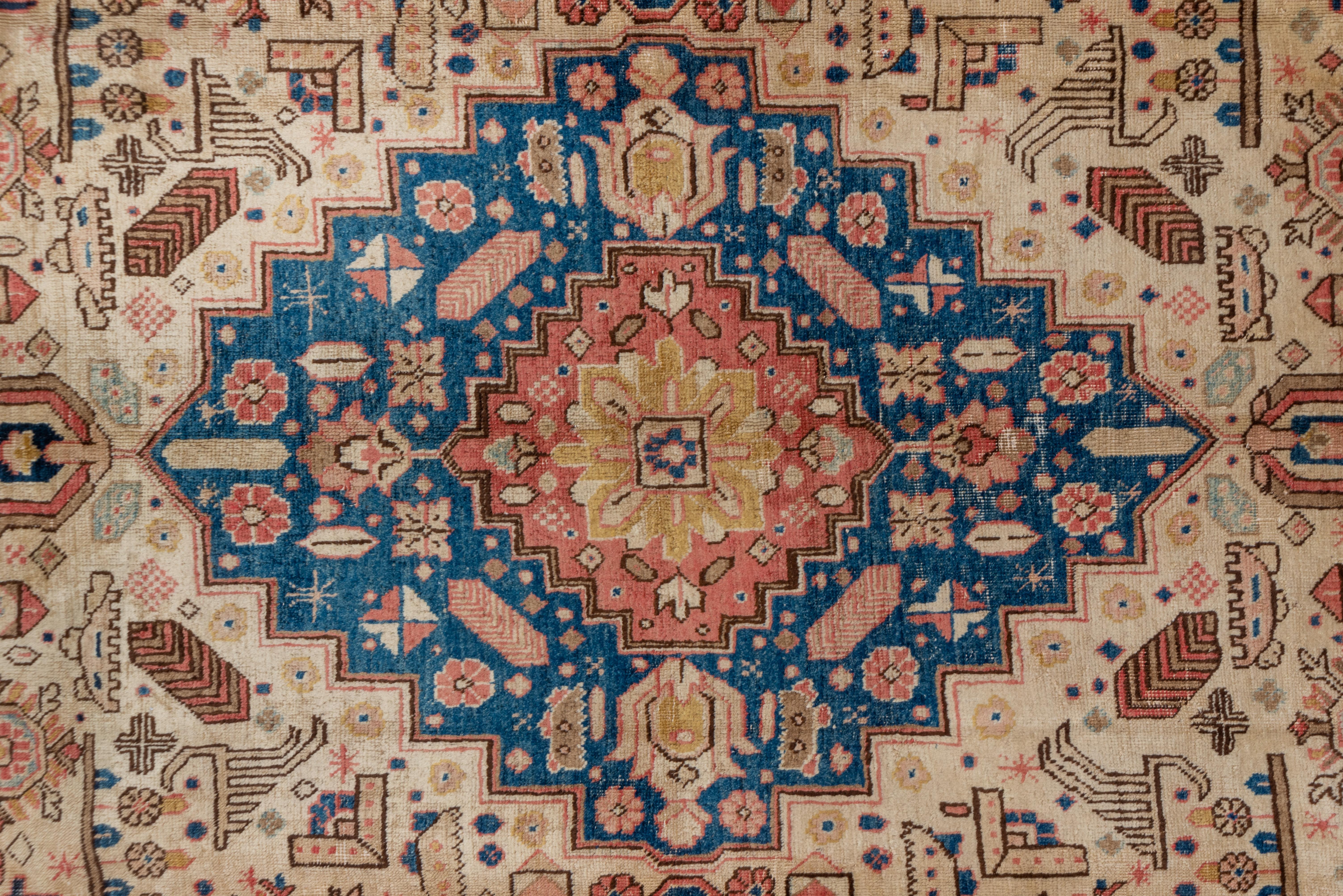 A rather more geometric Tabriz with a stepped, sharp, blue chain-pendanted medallion, dotted triangular corners and an unusual fill of stylized octagons, snowflakes, leaves and floating stems. Ecru field with matching border of vases and floating