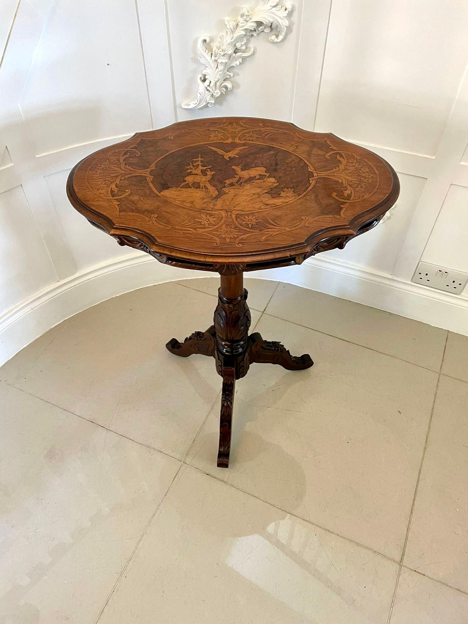 Unusual Antique Victorian quality marquetry inlaid walnut Swiss Black Forest table having a fantastic quality burr walnut marquetry beautifully inlaid serpentine shaped tilt top with decorated panels of mountain deer, lbex birds and foliage,